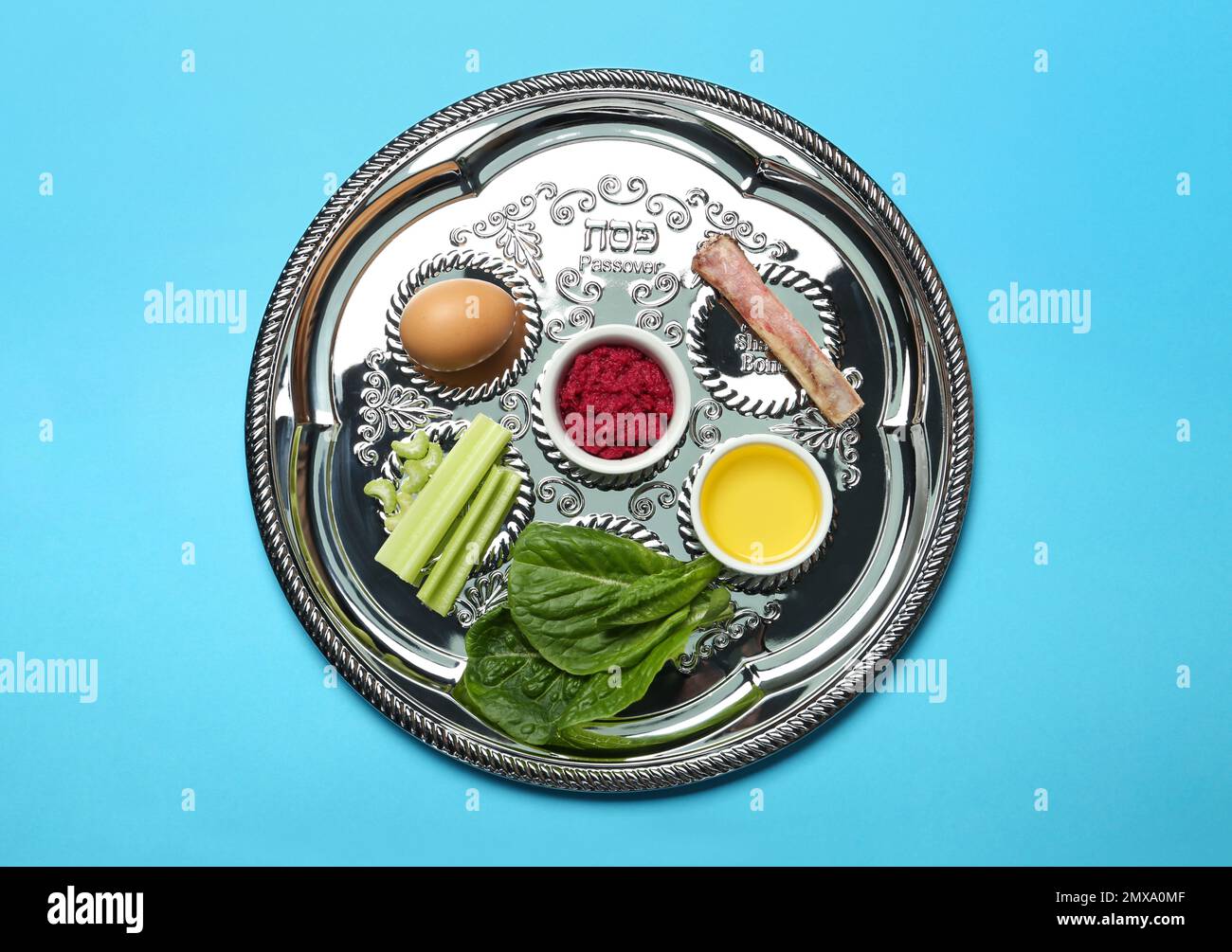 Passover Seder plate (keara) with symbolic meal on light blue