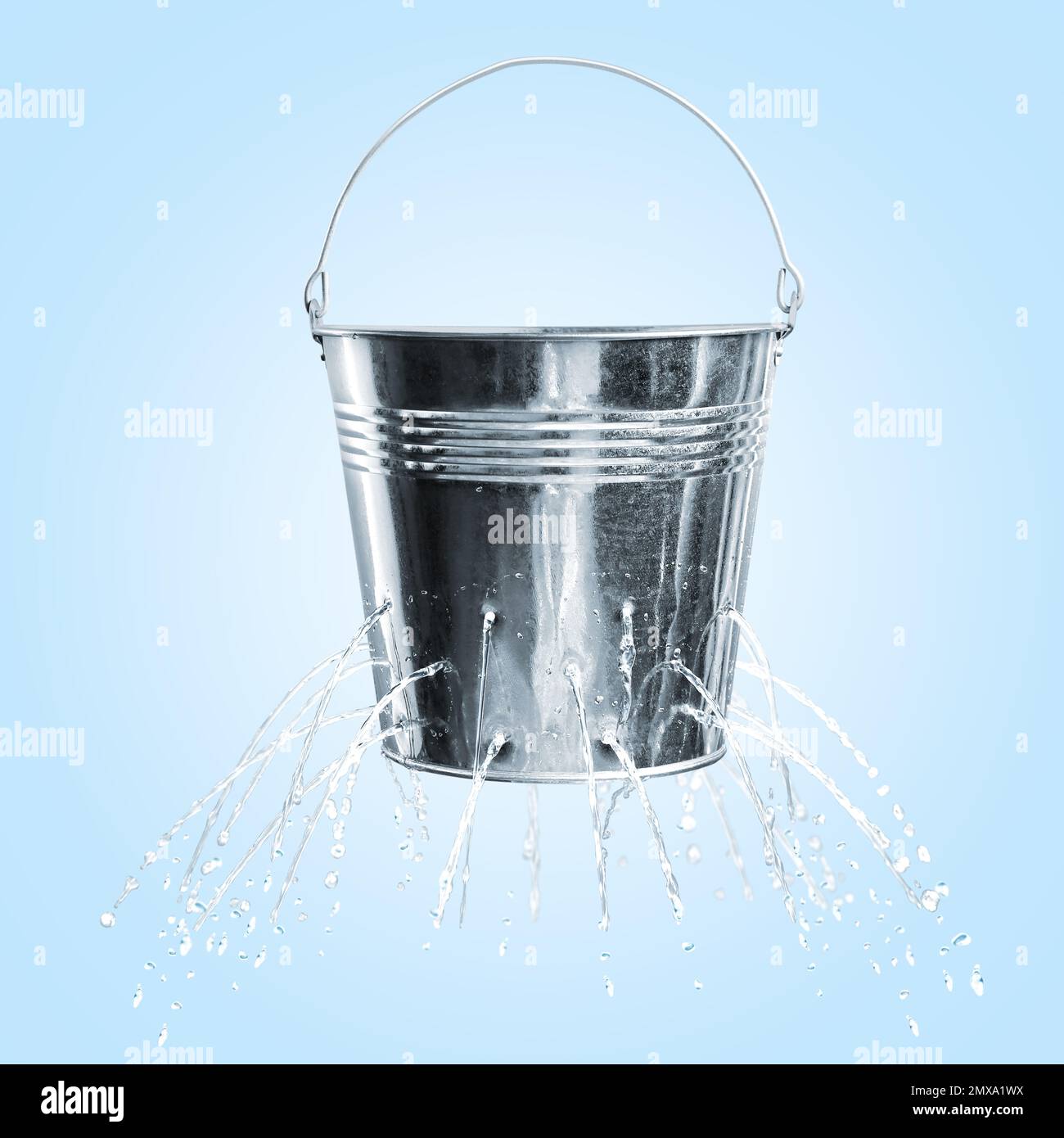 Leaky bucket with water on light blue background Stock Photo Alamy