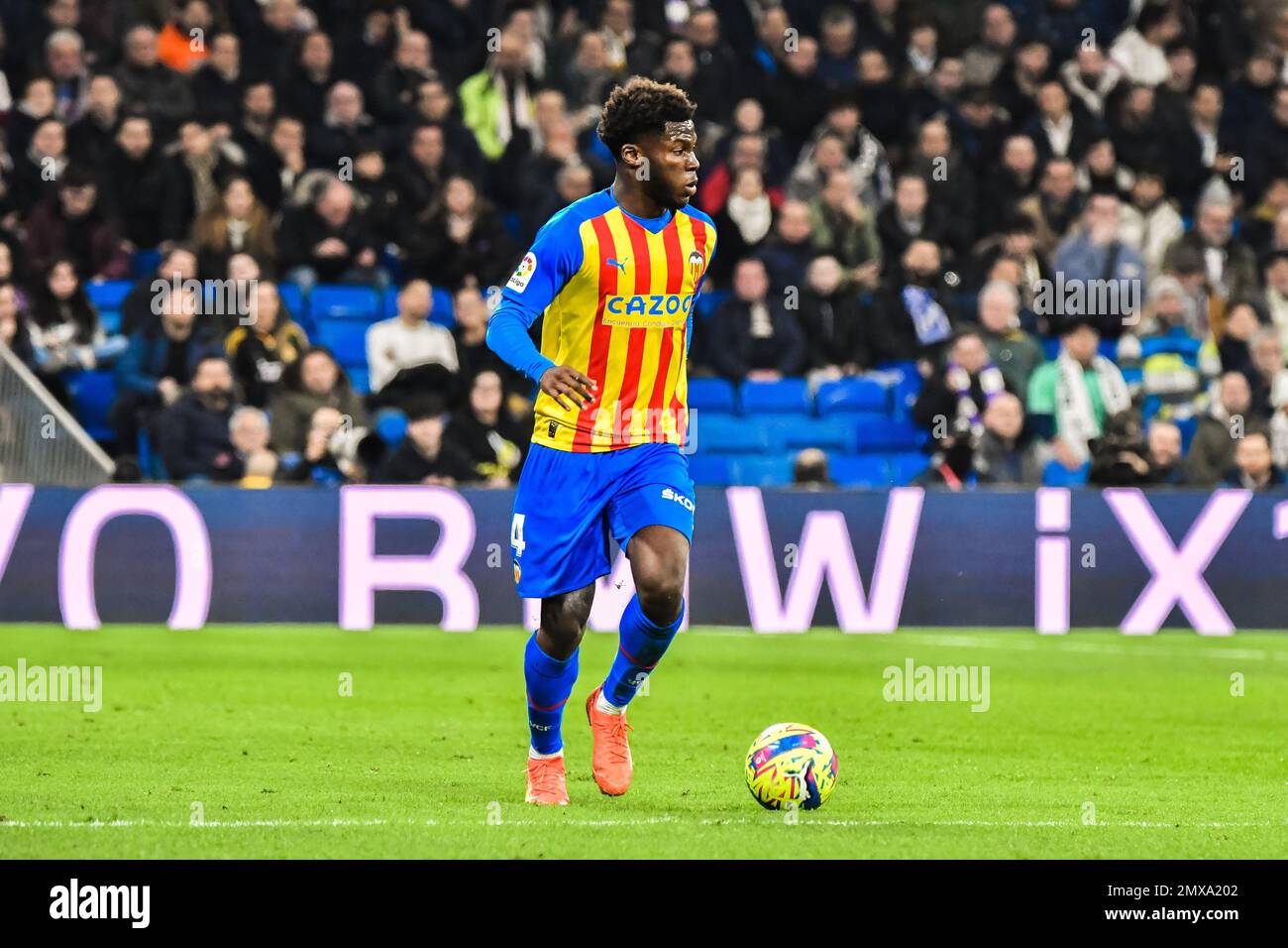 MADRID, SPAIN - FEBRUARY 2: Yunus Musah of Valencia CF drive the ball during the match between Real Madrid CF and Valencia CF of La Liga Santander on February 2, 2022 at Santiago Bernabeu of Madrid, Spain. (Photo by Samuel Carreño/ PX Images) Stock Photo
