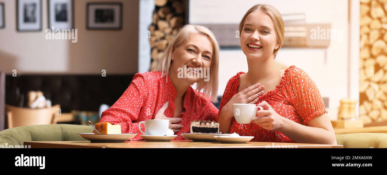 Mother and her adult daughter spending time together in cafe. Banner ...