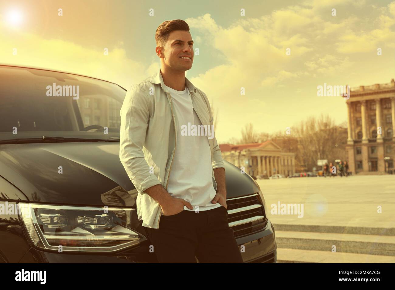 Handsome man near modern car on city street Stock Photo - Alamy