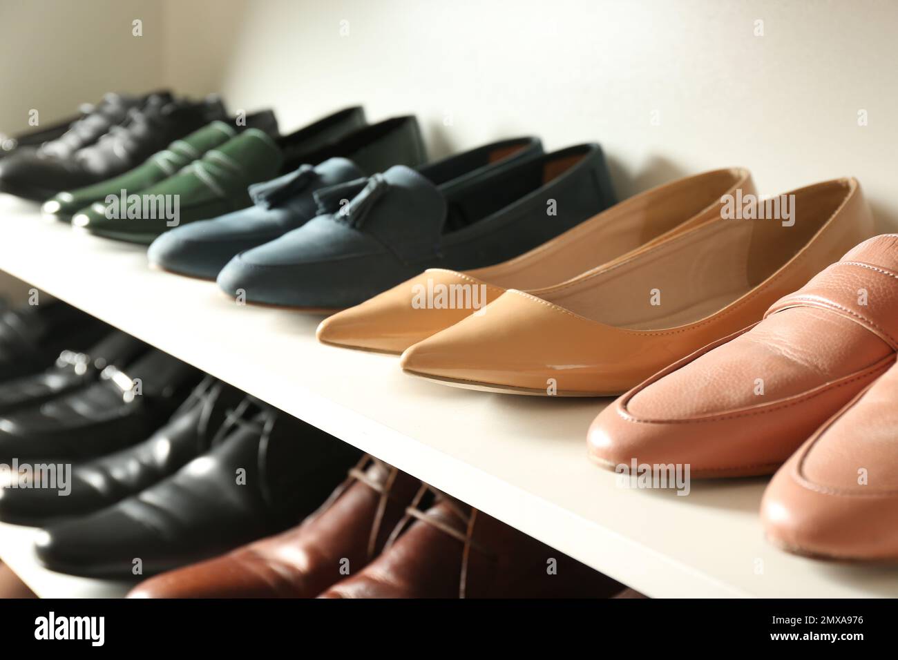 White shelving unit with different leather shoes Stock Photo Alamy