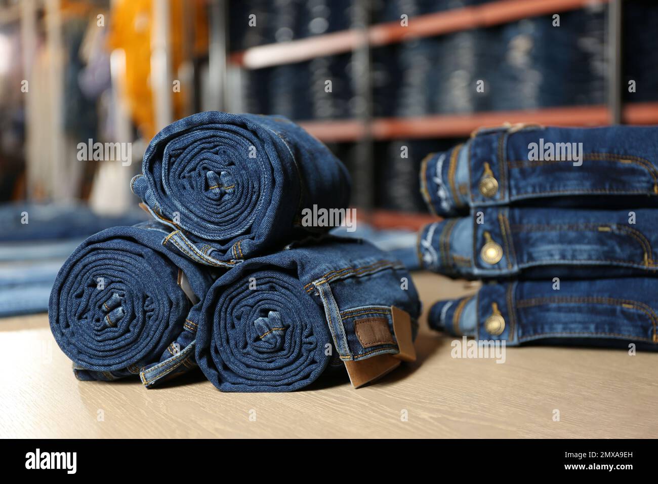 Rolled modern jeans on display in shop Stock Photo Alamy