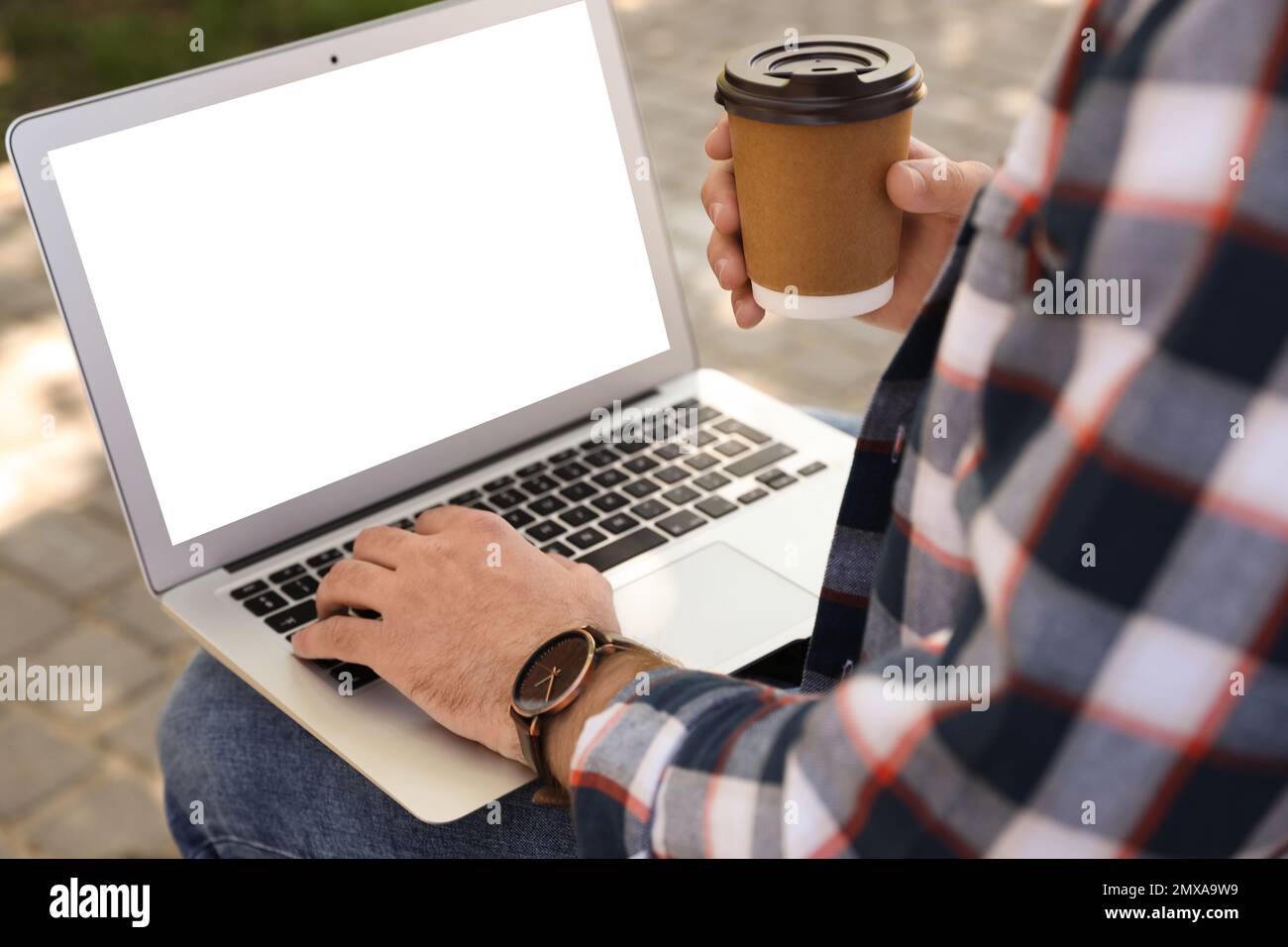 Young man using modern computer outdoors, closeup. Space for design ...