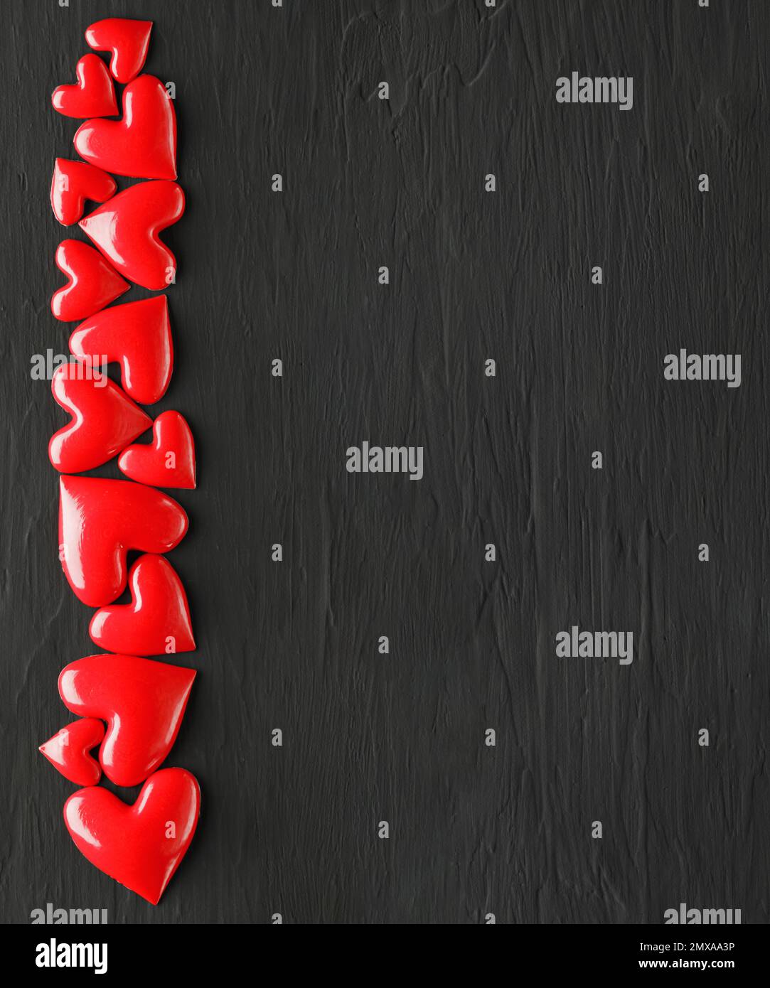 Collection of shiny red hearts on dark rough background Stock Photo - Alamy