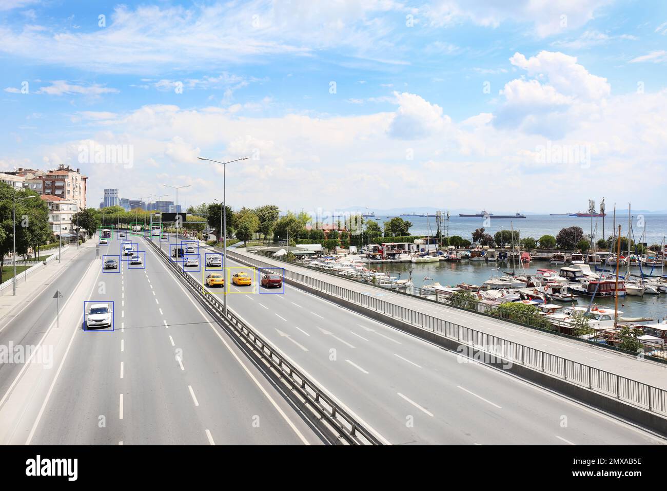 City road with scanner frames on cars near sea. Machine learning Stock