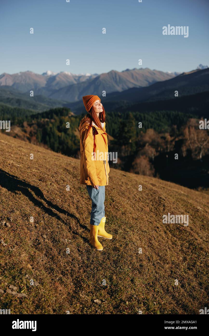 Woman in the autumn smile with teeth full-length walk on the hill and ...