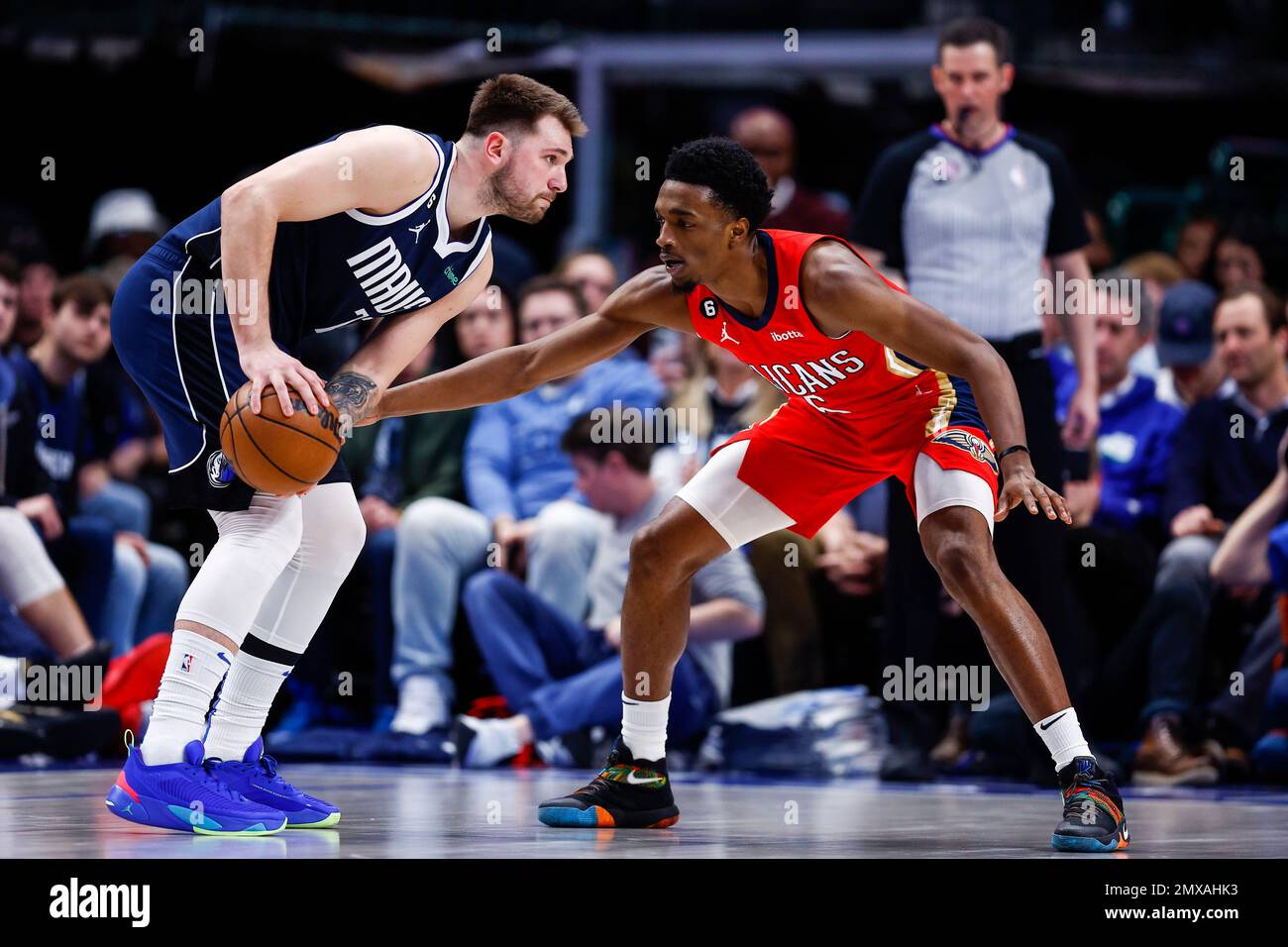 Dallas Mavericks guard Luka Doncic, left, looks for room against New