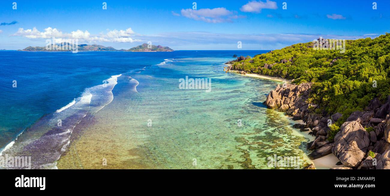 Aerial view of Anse Source d'Argent beach on La Digue, Seychelles with the island of Praslin in the distance Stock Photo