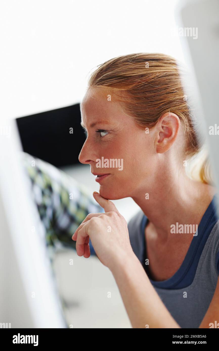 Curious about her progress. Two colleagues working on a computer together. Stock Photo