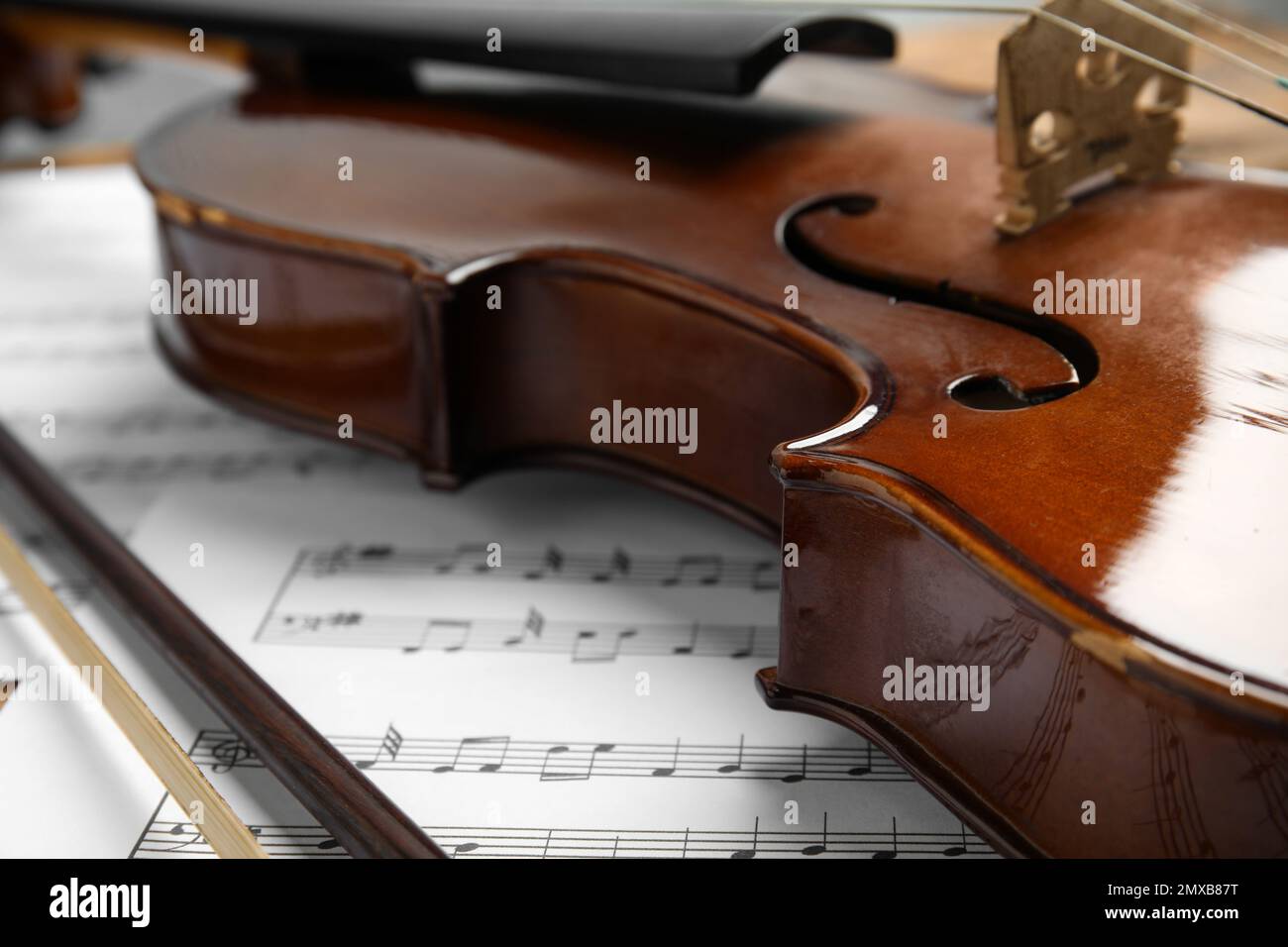Beautiful violin, bow and note sheets, closeup Stock Photo