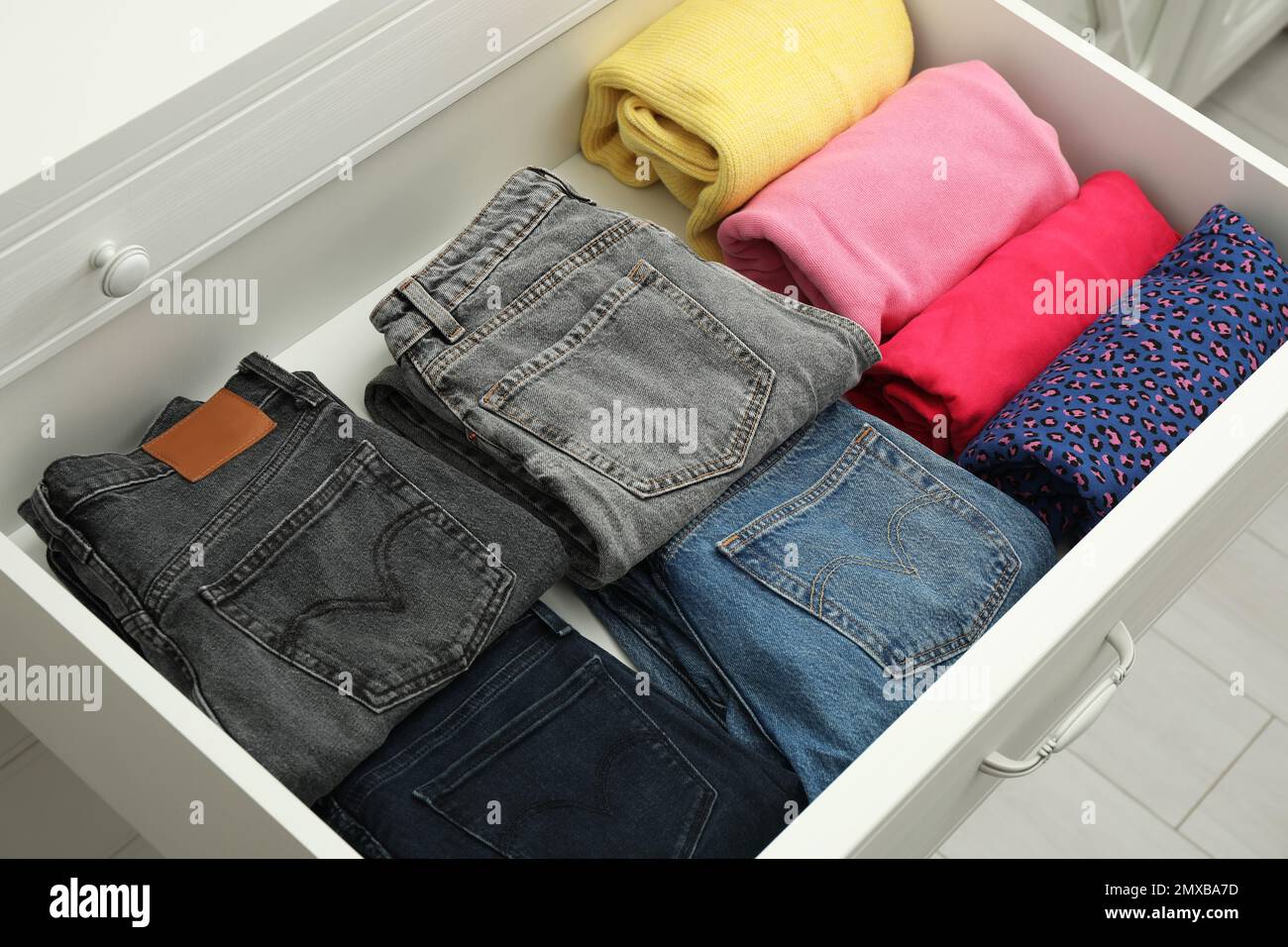 Folded clothes in open drawer. Apparel storage Stock Photo Alamy