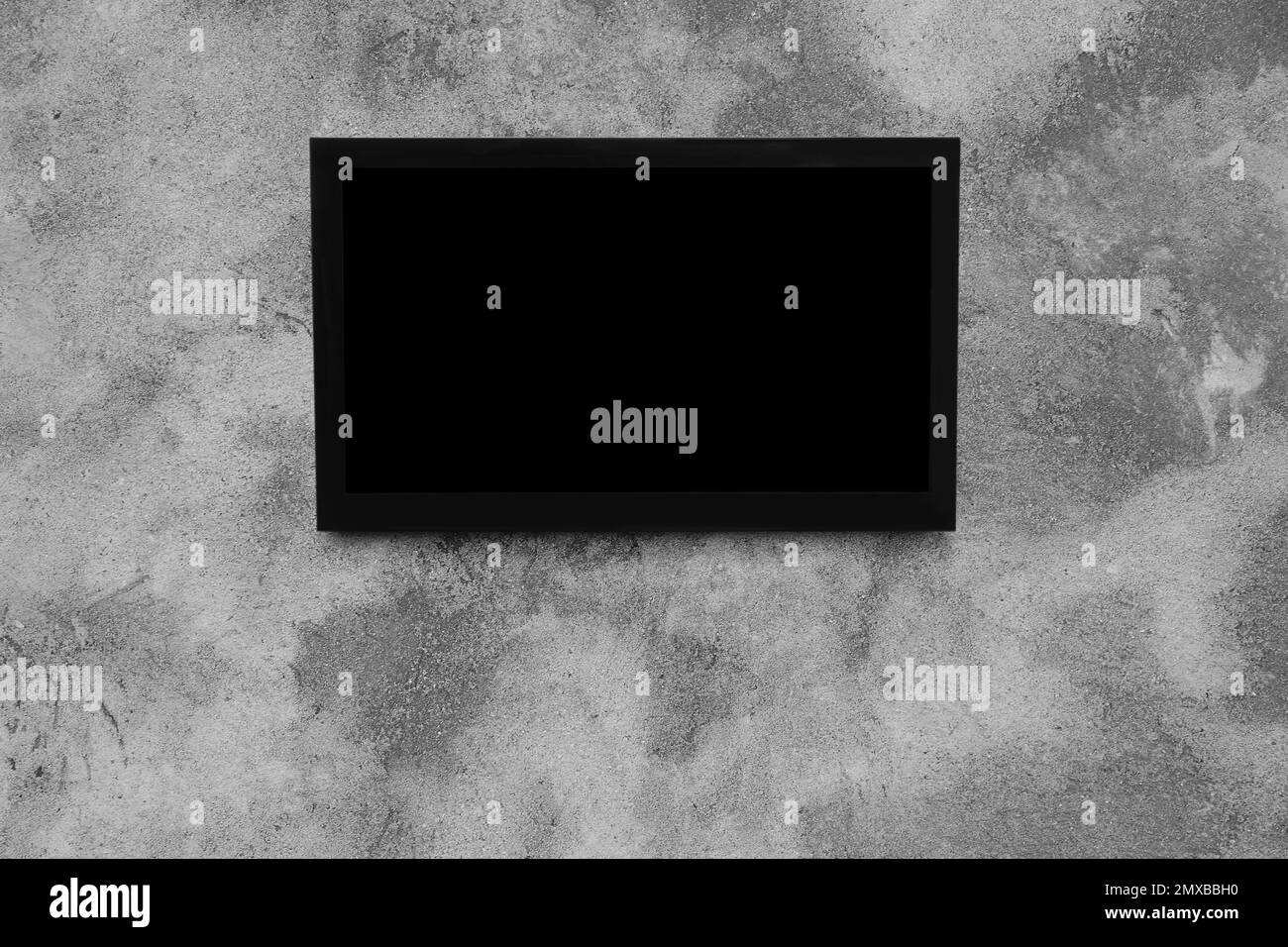 Modern TV on grey wall. Space for design Stock Photo - Alamy