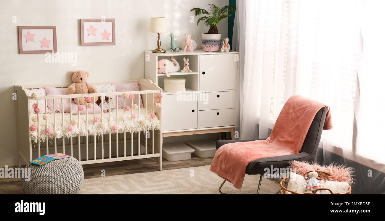 Baby room interior with comfortable crib. Banner design Stock Photo - Alamy