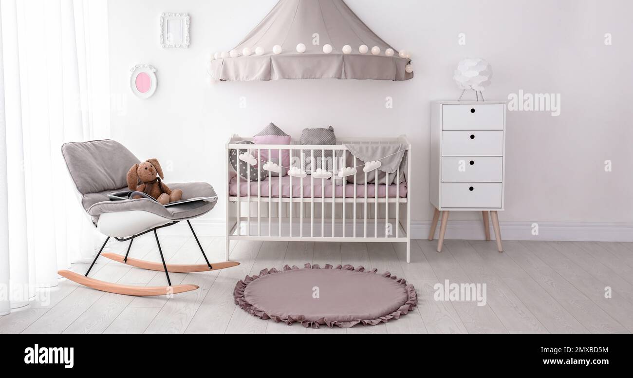 Baby room interior with comfortable crib. Banner design Stock Photo - Alamy