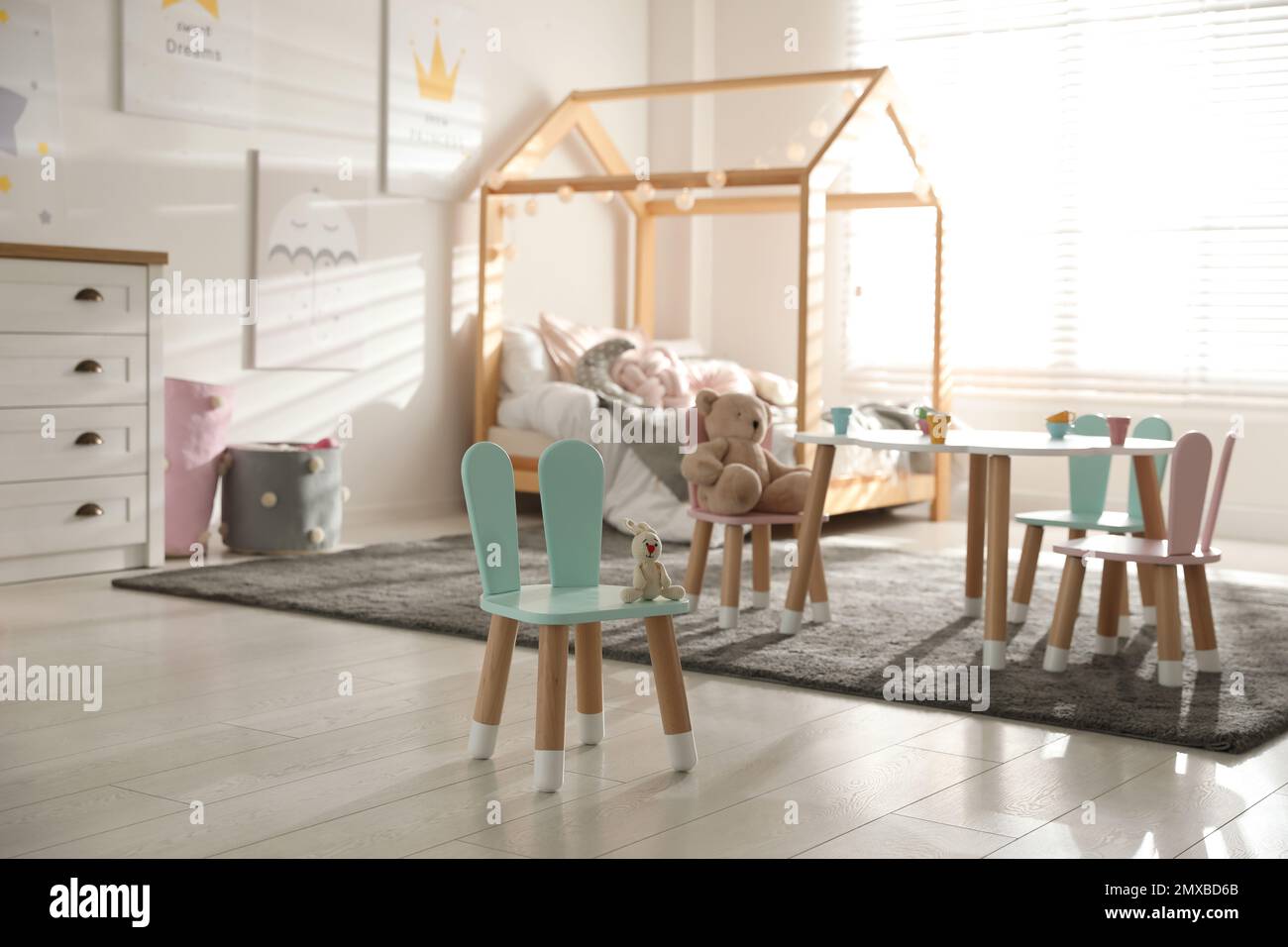 Small table and chairs with bunny ears in children s bedroom