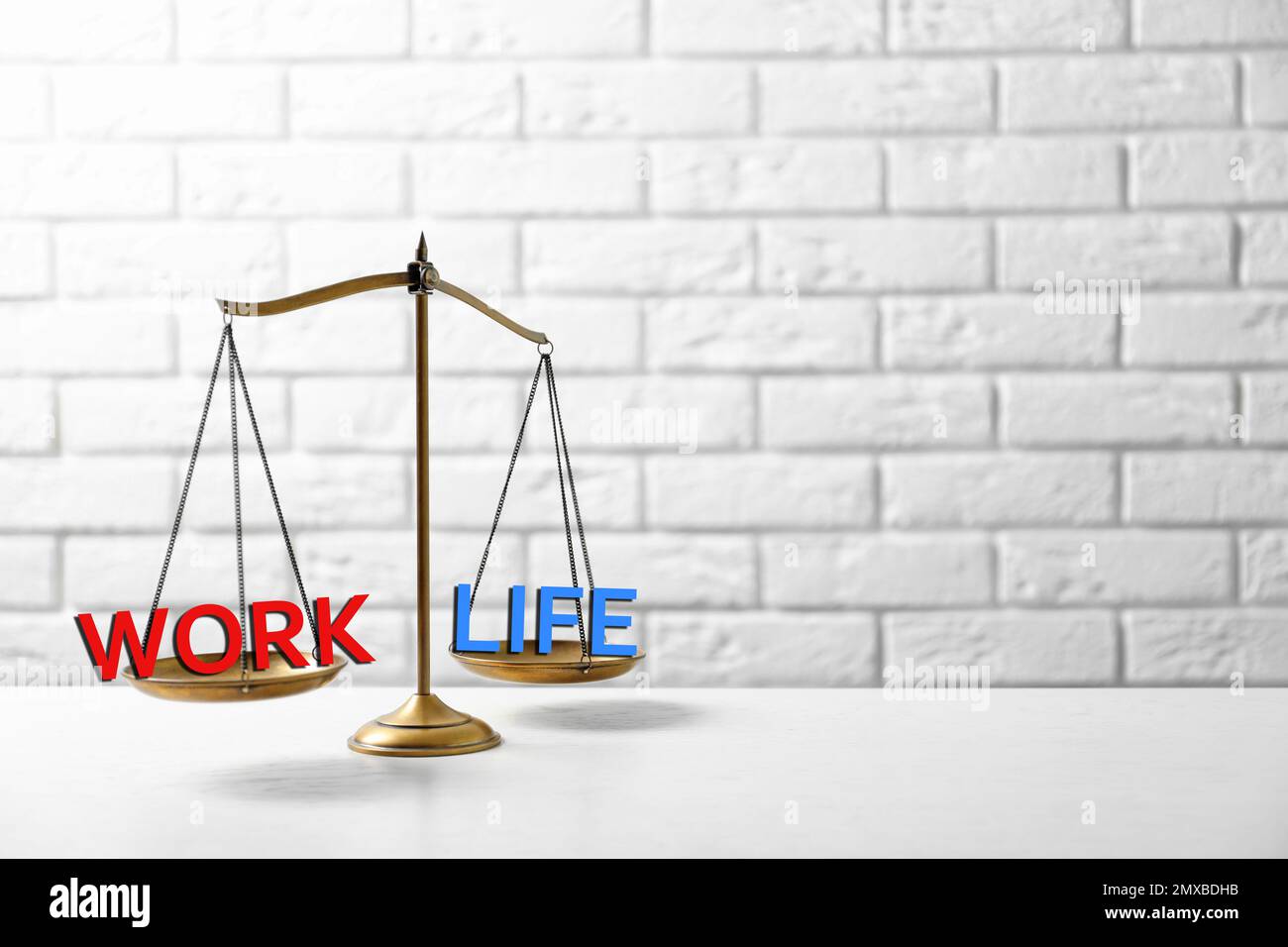 Work-life balance concept. Scale with words on table, space for text ...