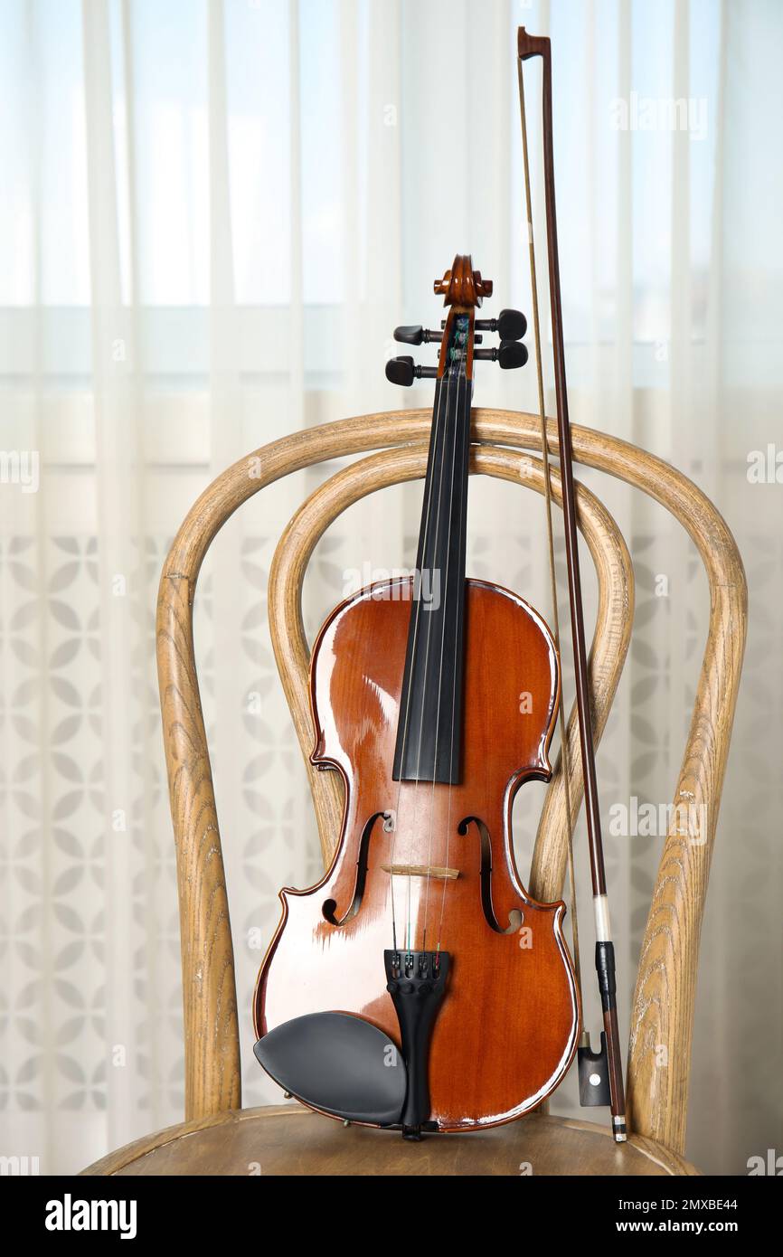 Classic violin and bow on chair indoors Stock Photo Alamy
