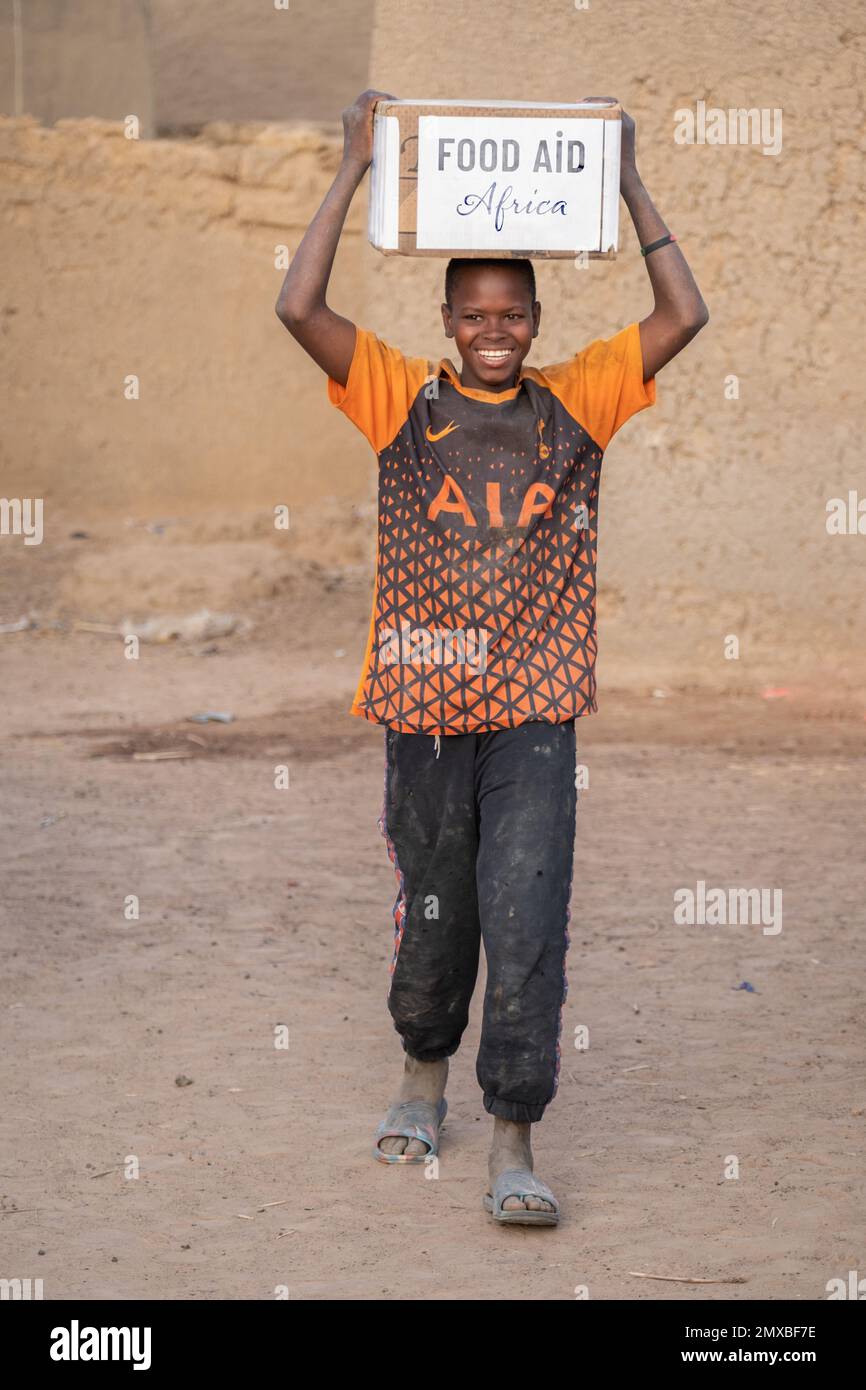 Food aid during Ramadan in Africa. iftar treat and happy people Stock