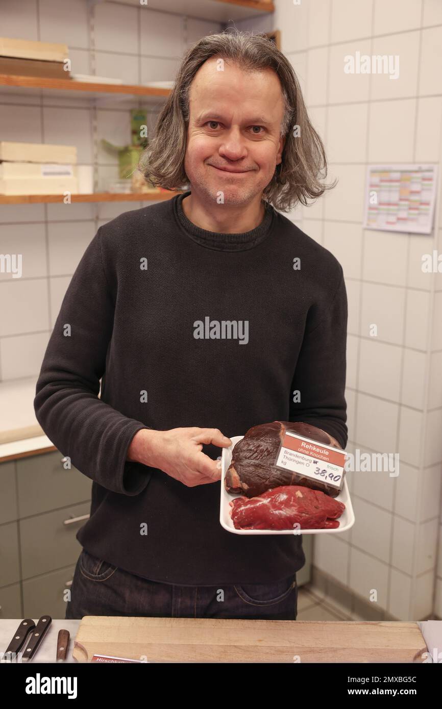 Berlin, Germany. 27th Jan, 2023. Lutz Albrecht from the Wild & Geflügel Albrecht butcher store stands in his store with a leg of venison. The prices for roe deer and wild boar have recently risen sharply, but venison is in demand. (to dpa 'Saddle of venison and leg of wild boar: coveted, but rare') Credit: Joerg Carstensen/dpa/Alamy Live News Stock Photo
