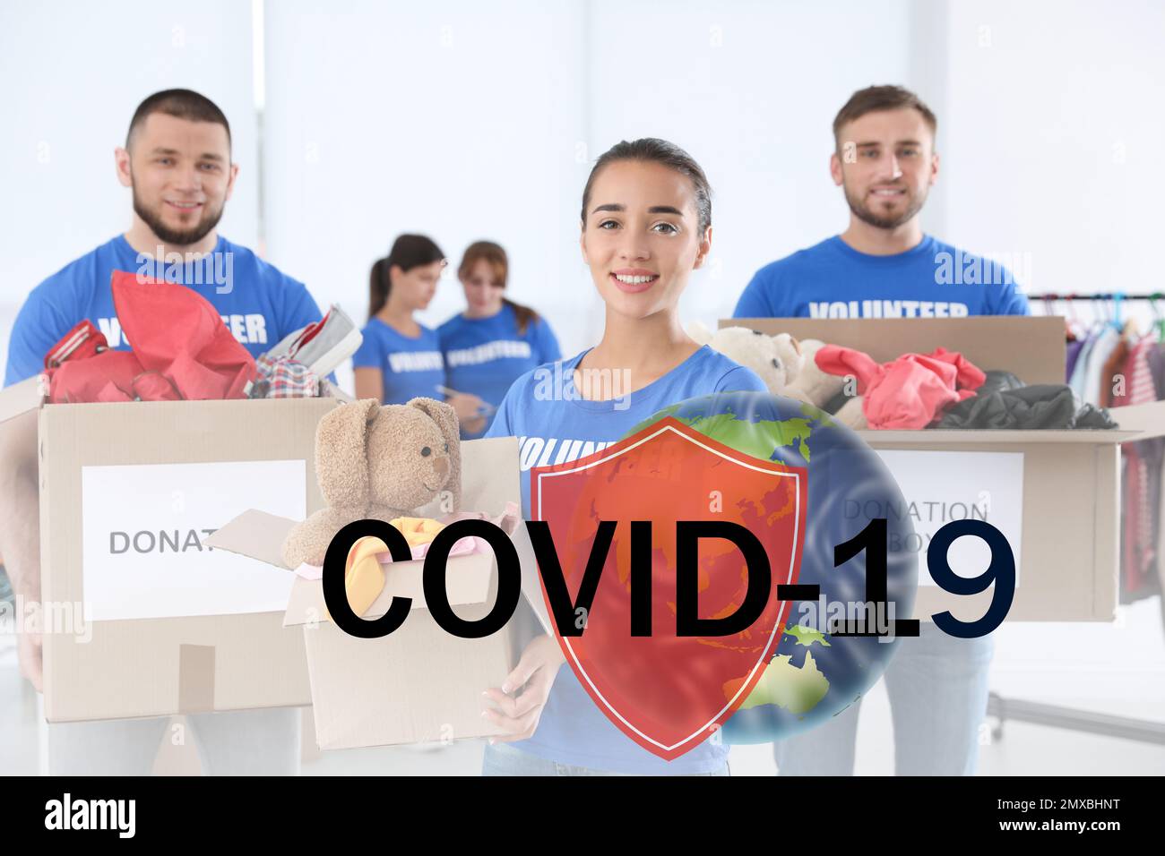 Volunteers uniting to help during COVID-19 outbreak. Group of people with donations indoors, shield and world globe illustrations Stock Photo