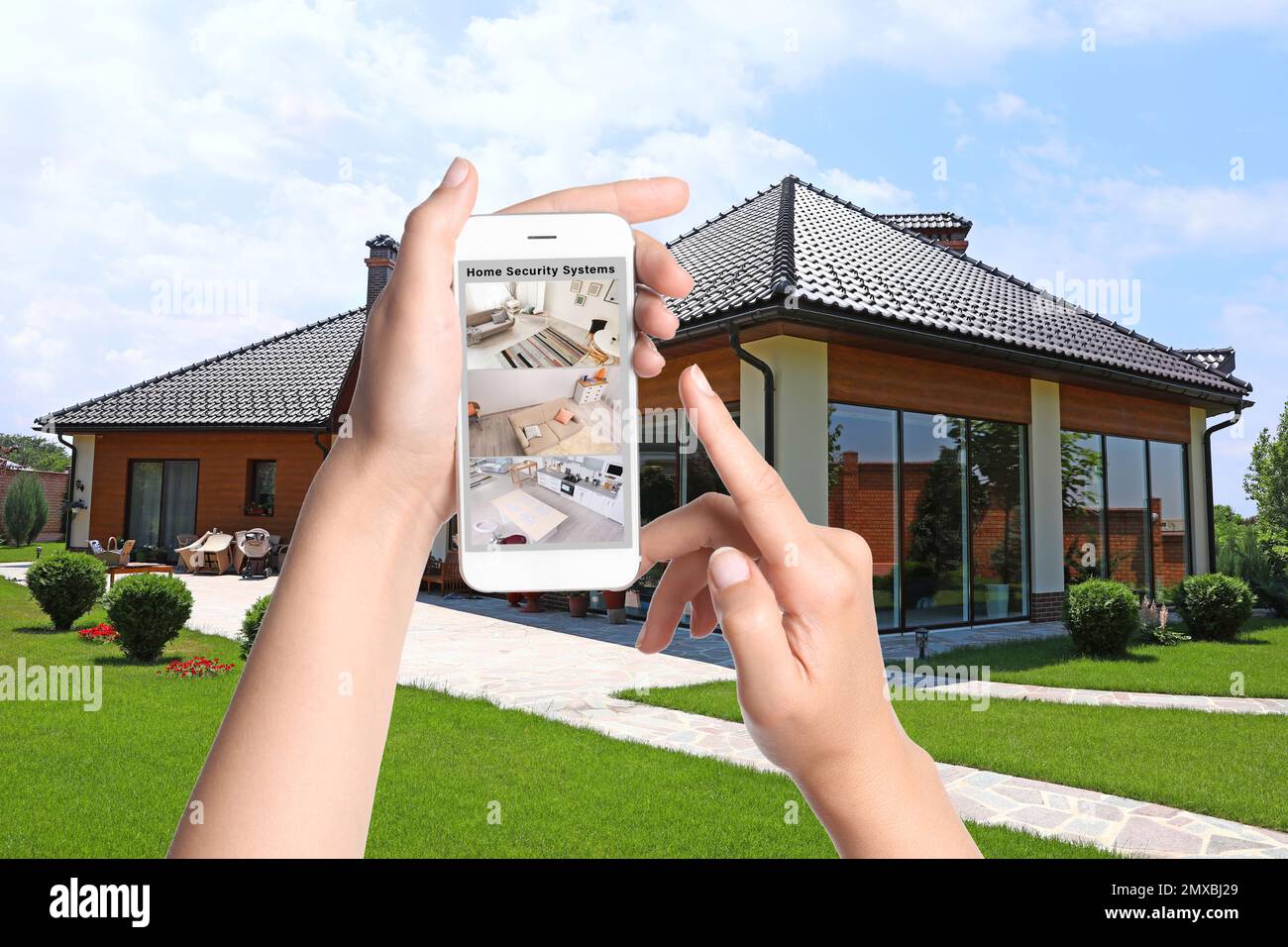 Alarm system. Woman monitoring modern CCTV cameras on smartphone near ...