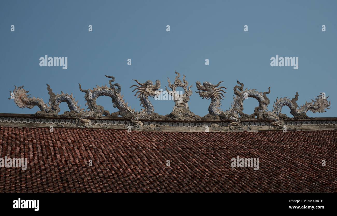 Dragon sculpture on the roof of a traditional Vietnamese pagoda Stock Photo