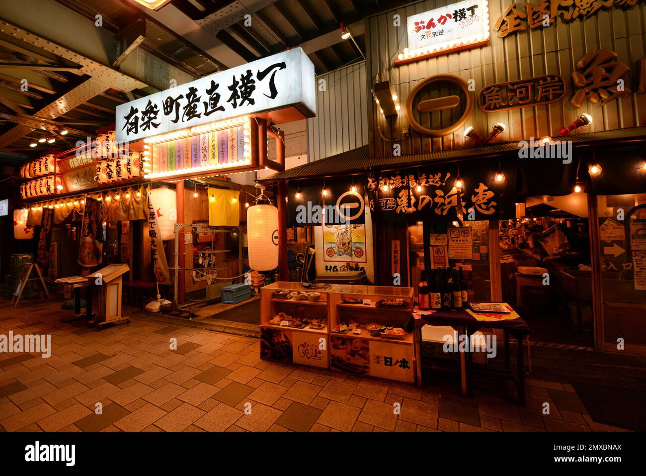 Bars and Izakayas under the JR elevated tracks between the Yurakucho and Shimbashi JR lines stations in Tokyo. Stock Photo