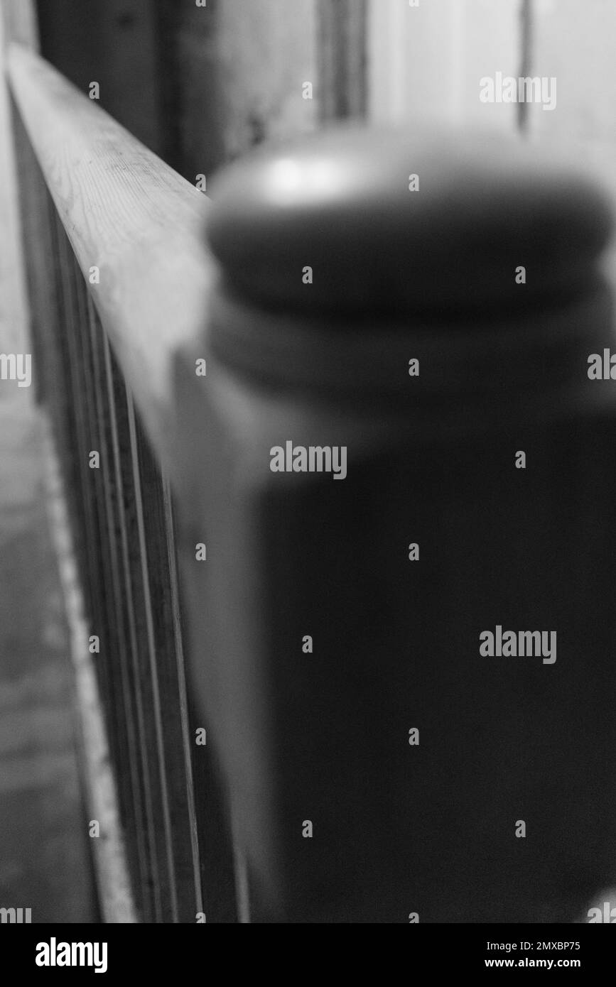 Black and white photo of wooden banister in house Stock Photo