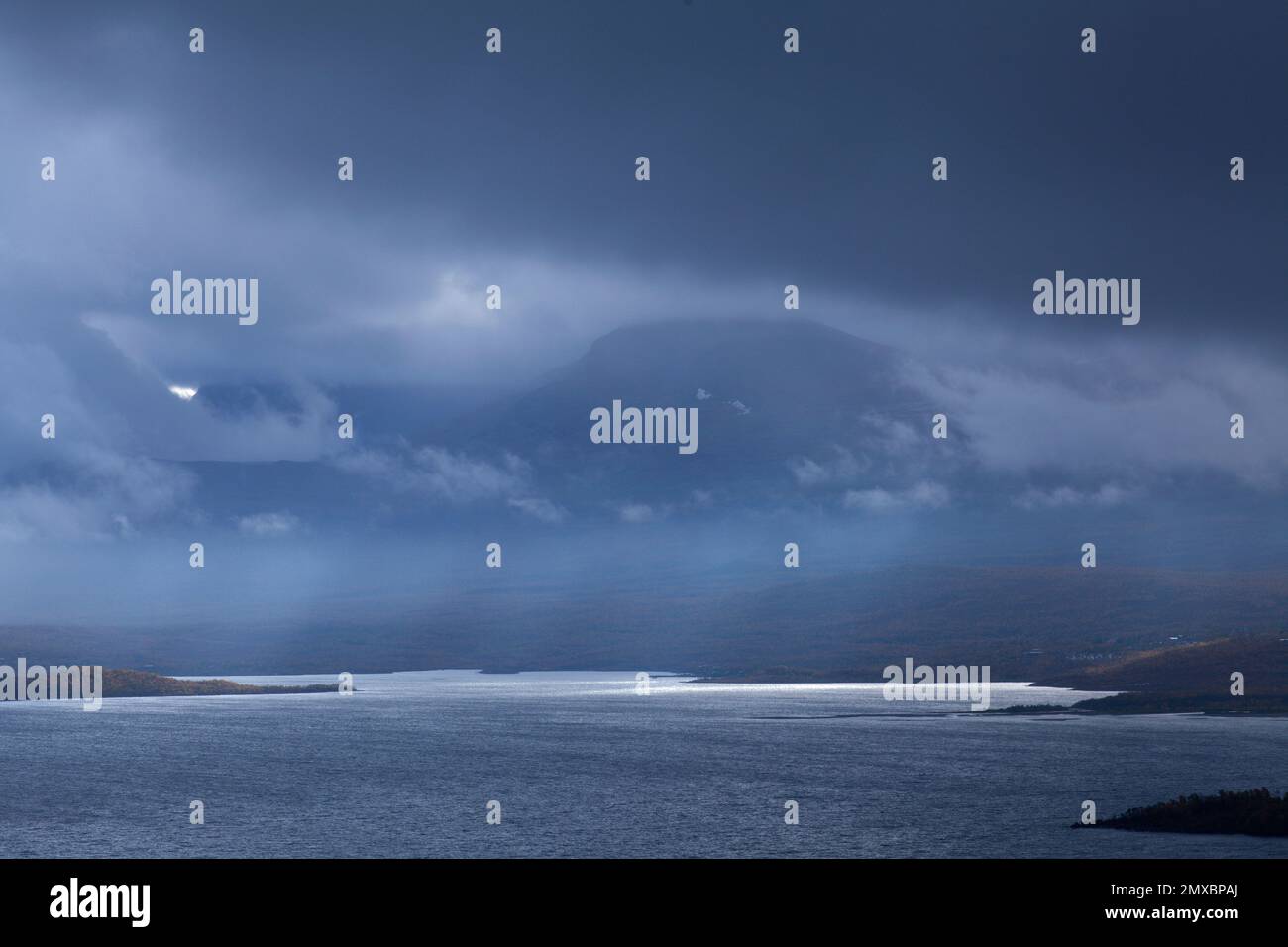Cloudscape, nightfall in the Lapland mountains. Lake on this side and