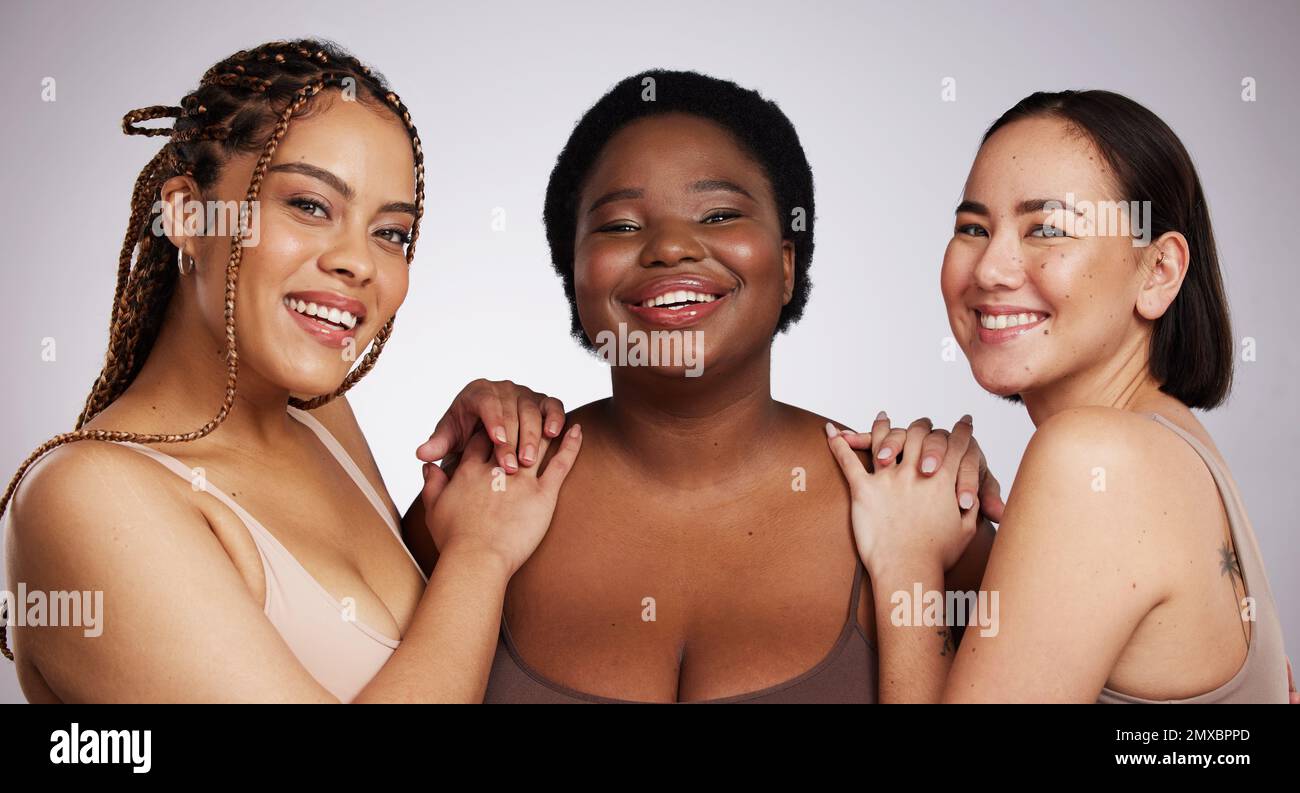 Portrait, diversity and women with skincare, cosmetics and happiness on grey studio background. Multiracial, females and ladies with empowerment Stock Photo
