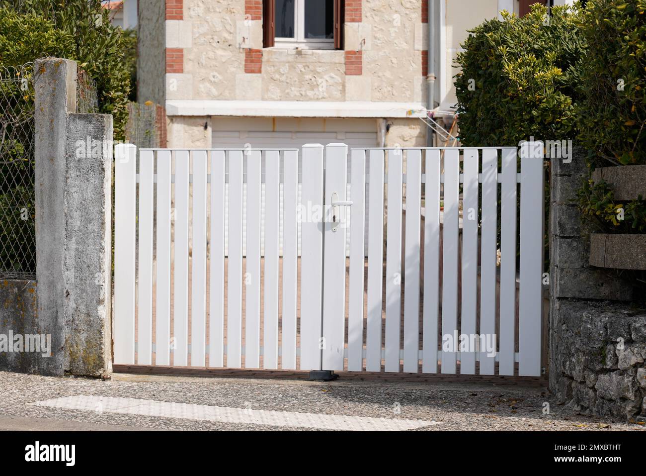 classic white gate aluminum portal with blades design of suburban house Stock Photo