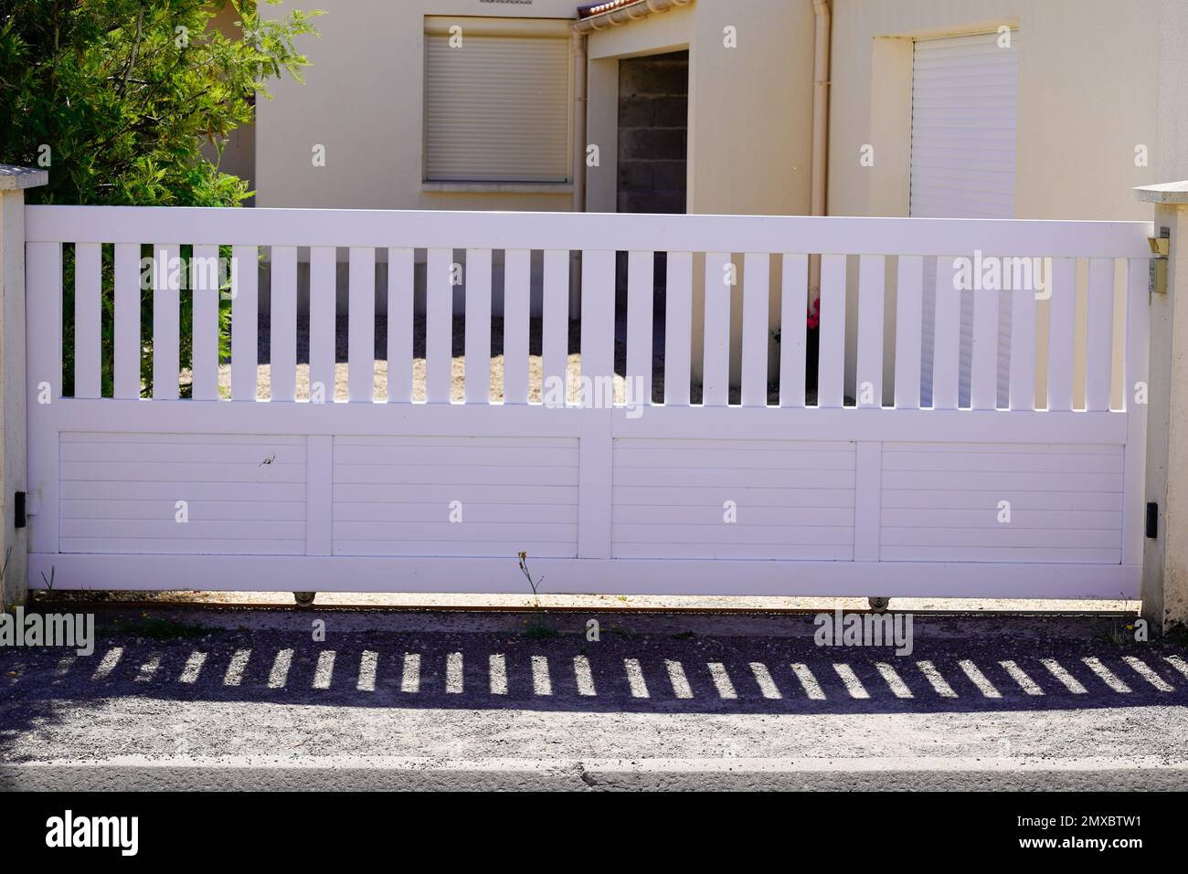 sliding white modern slide gate aluminum portal with blades design of suburban house Stock Photo