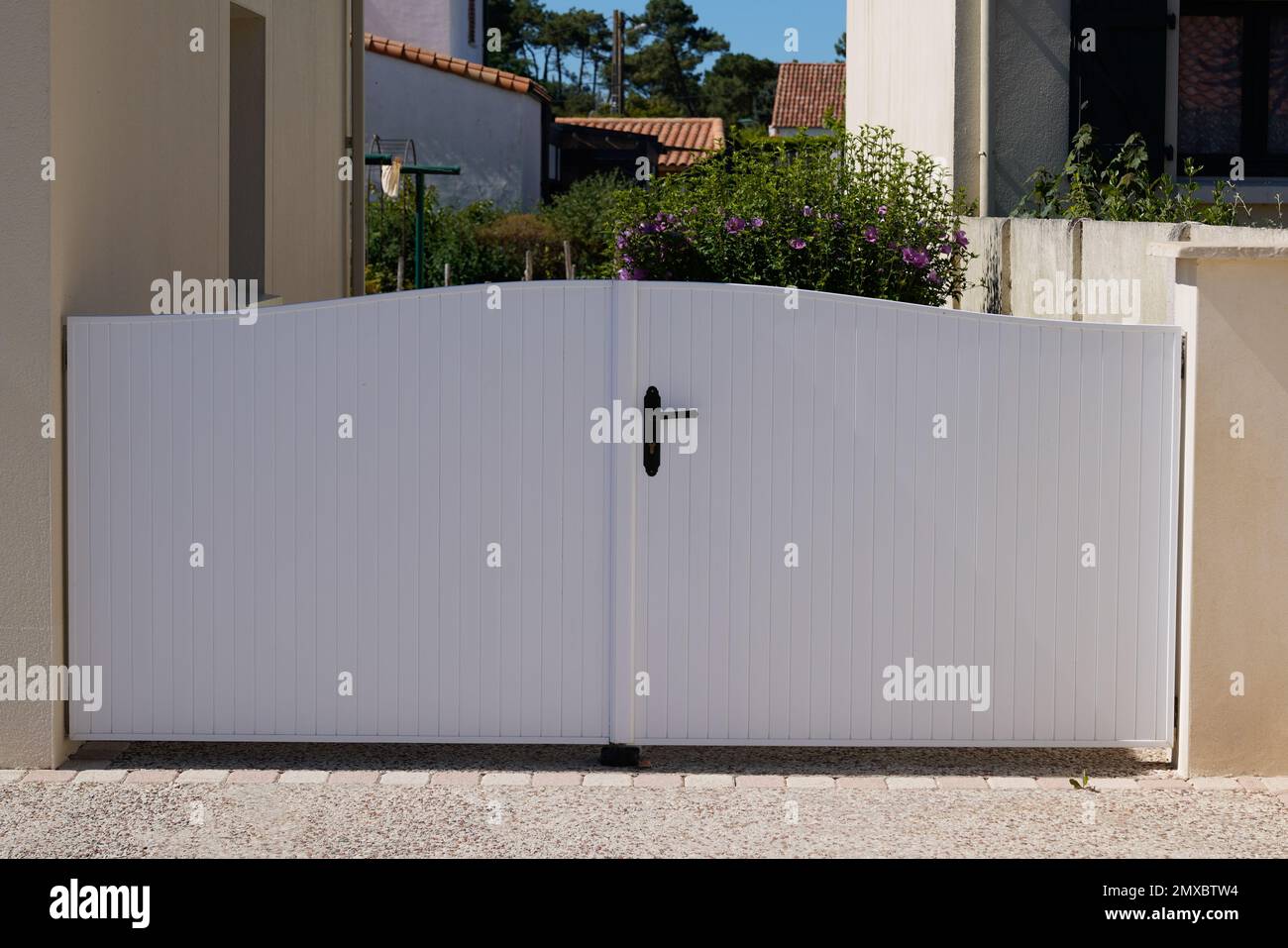 classic full white gate aluminum portal with blades design of suburban house Stock Photo