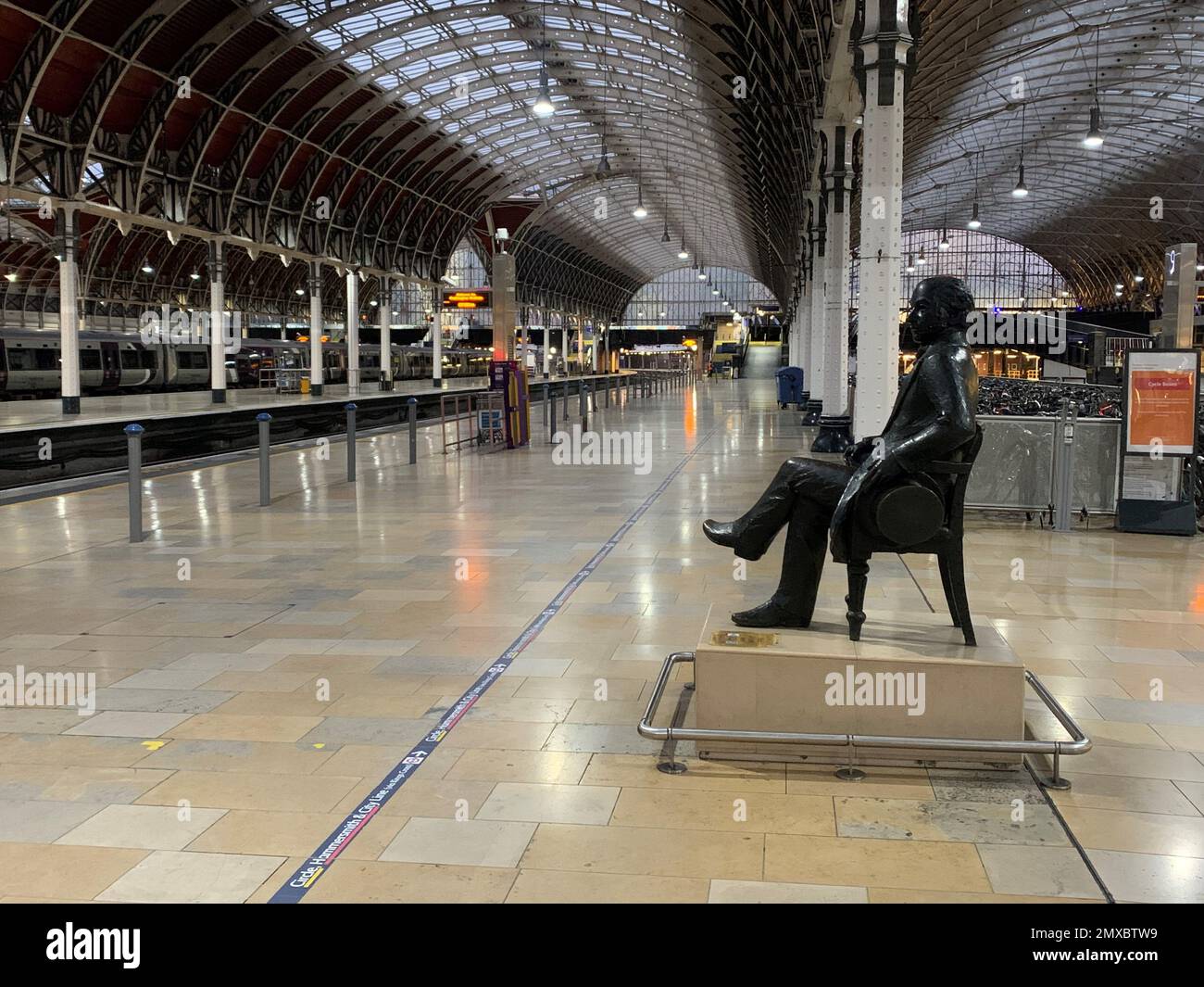 A statue of Isambard Kingdom Brunel sits on an empty platform at Paddington train station in