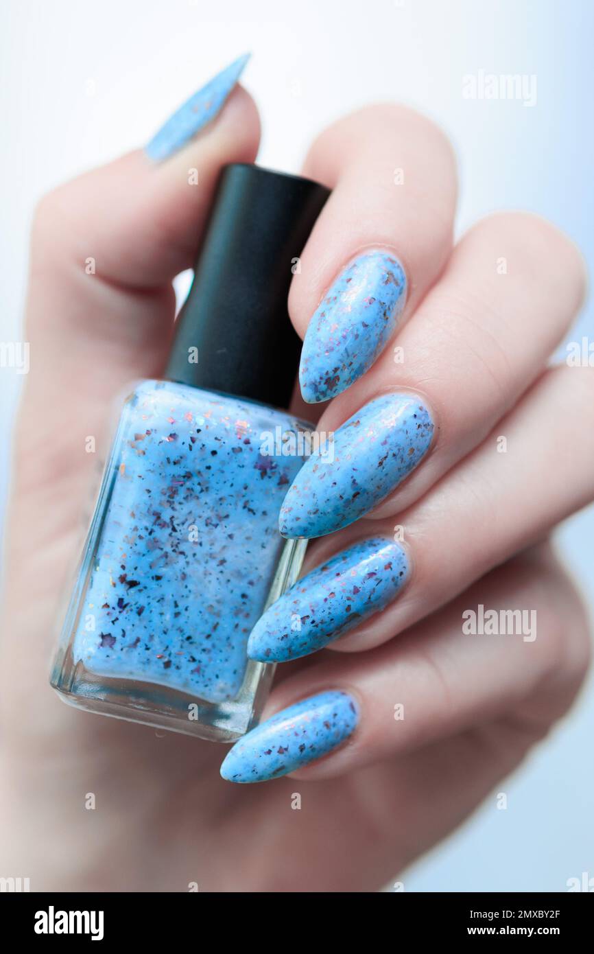 Female hand with long nails and light blue french nail polish Stock Photo -  Alamy