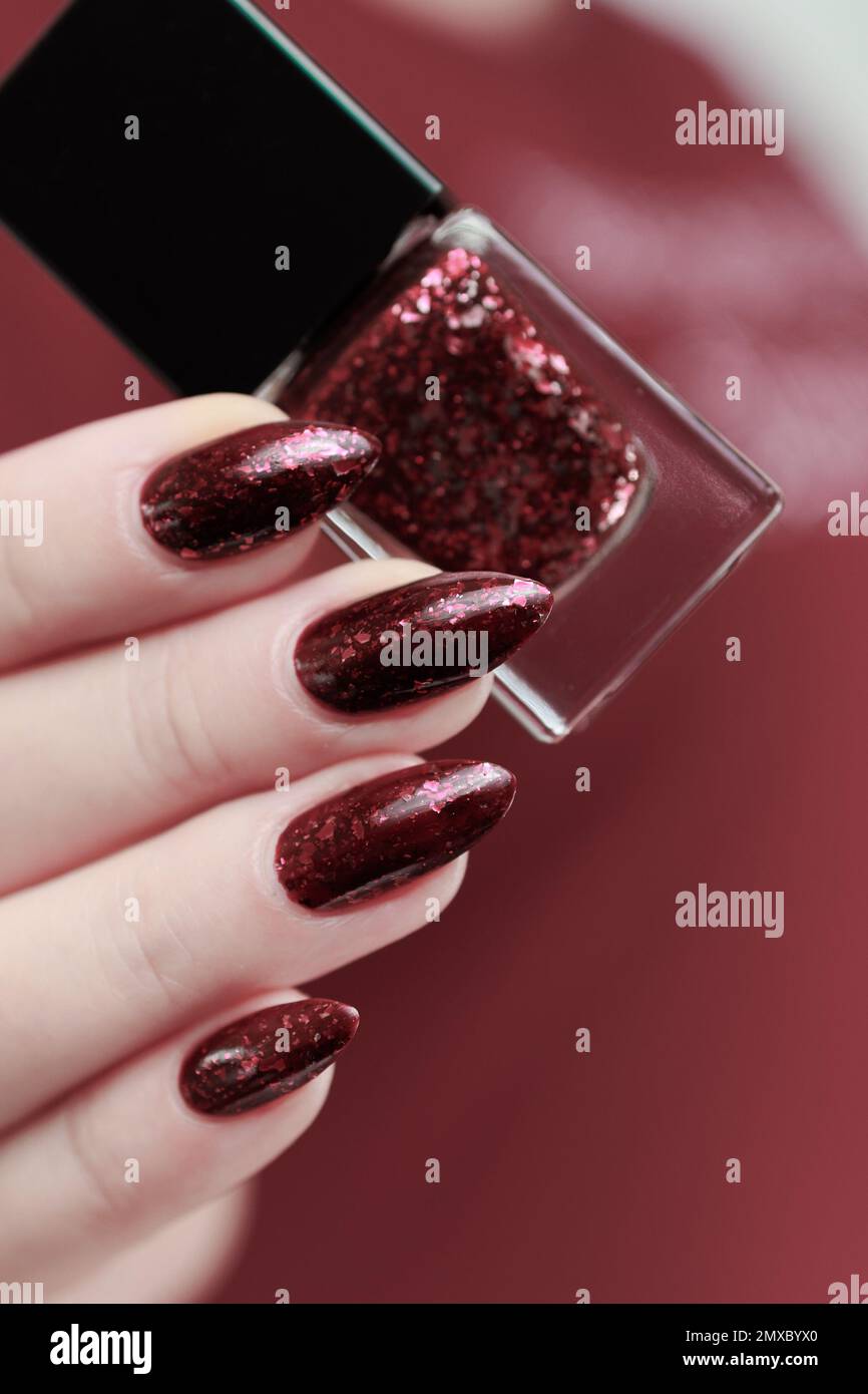 Closeup woman hand with burgundy red nail polish on fingernails. Burgundy  nail manicure with gel polish at luxury beauty salon. French manicure. Nail  art and design. Female hand model. Generative AI. 32087662