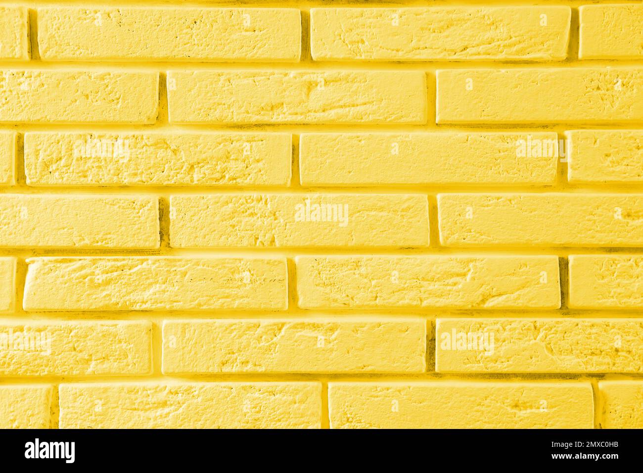 Stylish yellow brick wall as background. Simple design Stock Photo - Alamy