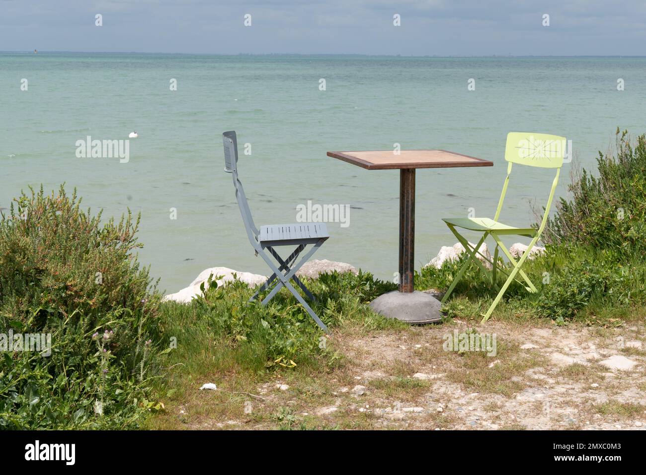 vintage green table and blue chairs in seaside beach ile de re in