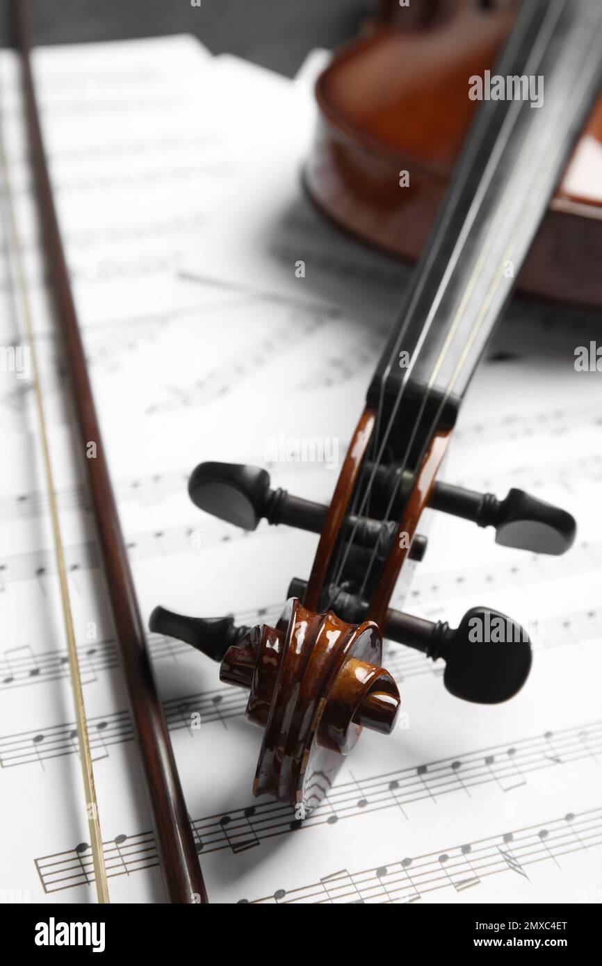 Classic violin, bow on note sheets, closeup Stock Photo