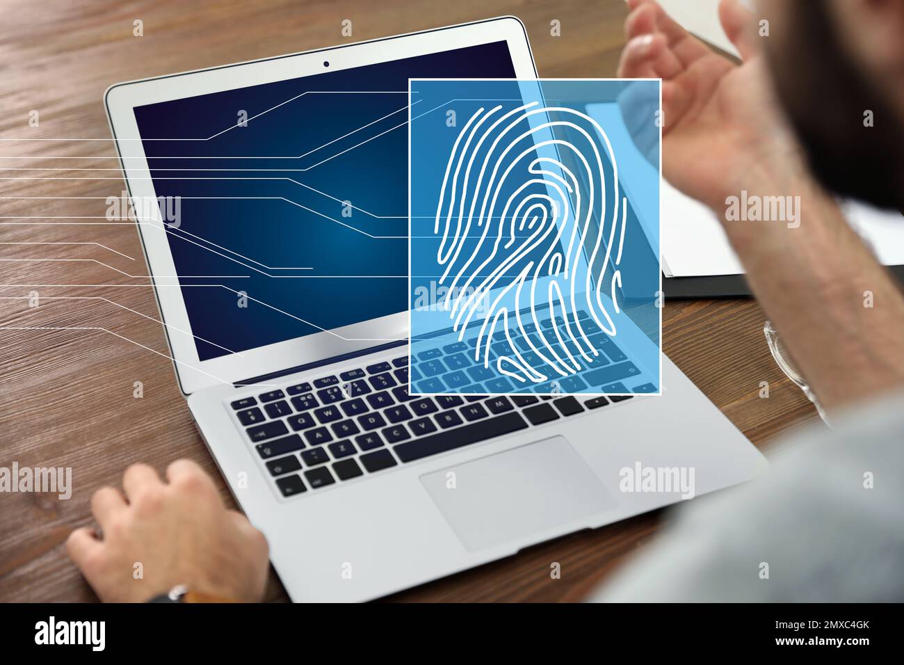 Fingerprint identification. Man working with laptop at table, closeup ...