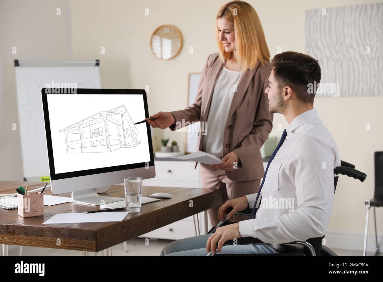 Architects making project of house on computer in office Stock Photo ...