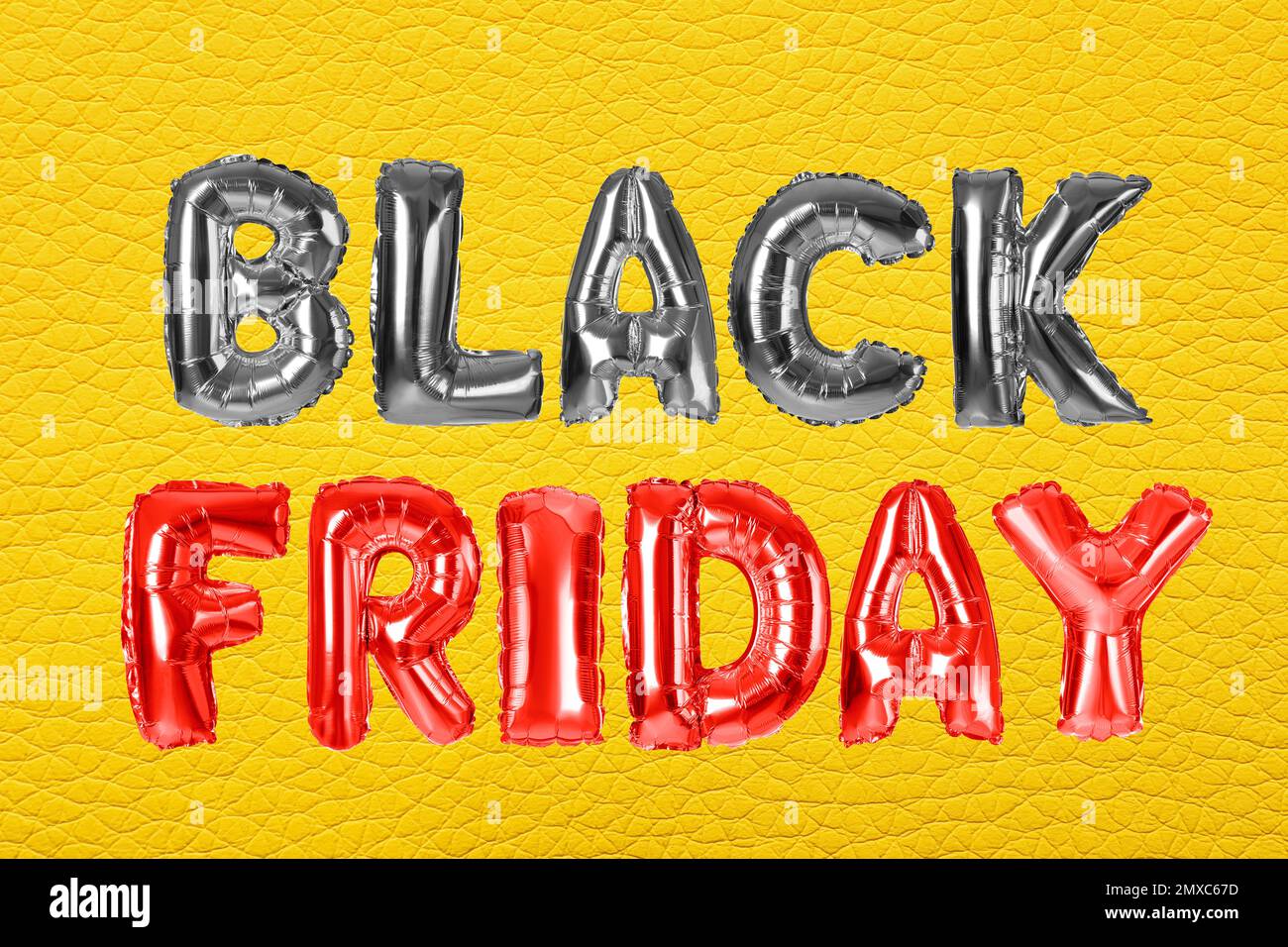 Phrase BLACK FRIDAY made of foil balloon letters on yellow background Stock Photo