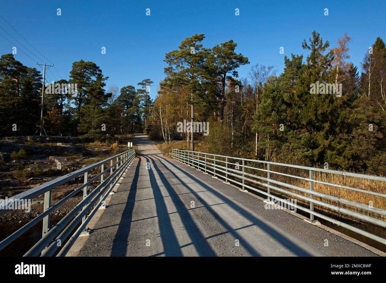 Bridge with metal railings at coast on a day with clear sky, Porkkala, Kirkkonummi, Finland. Stock Photo