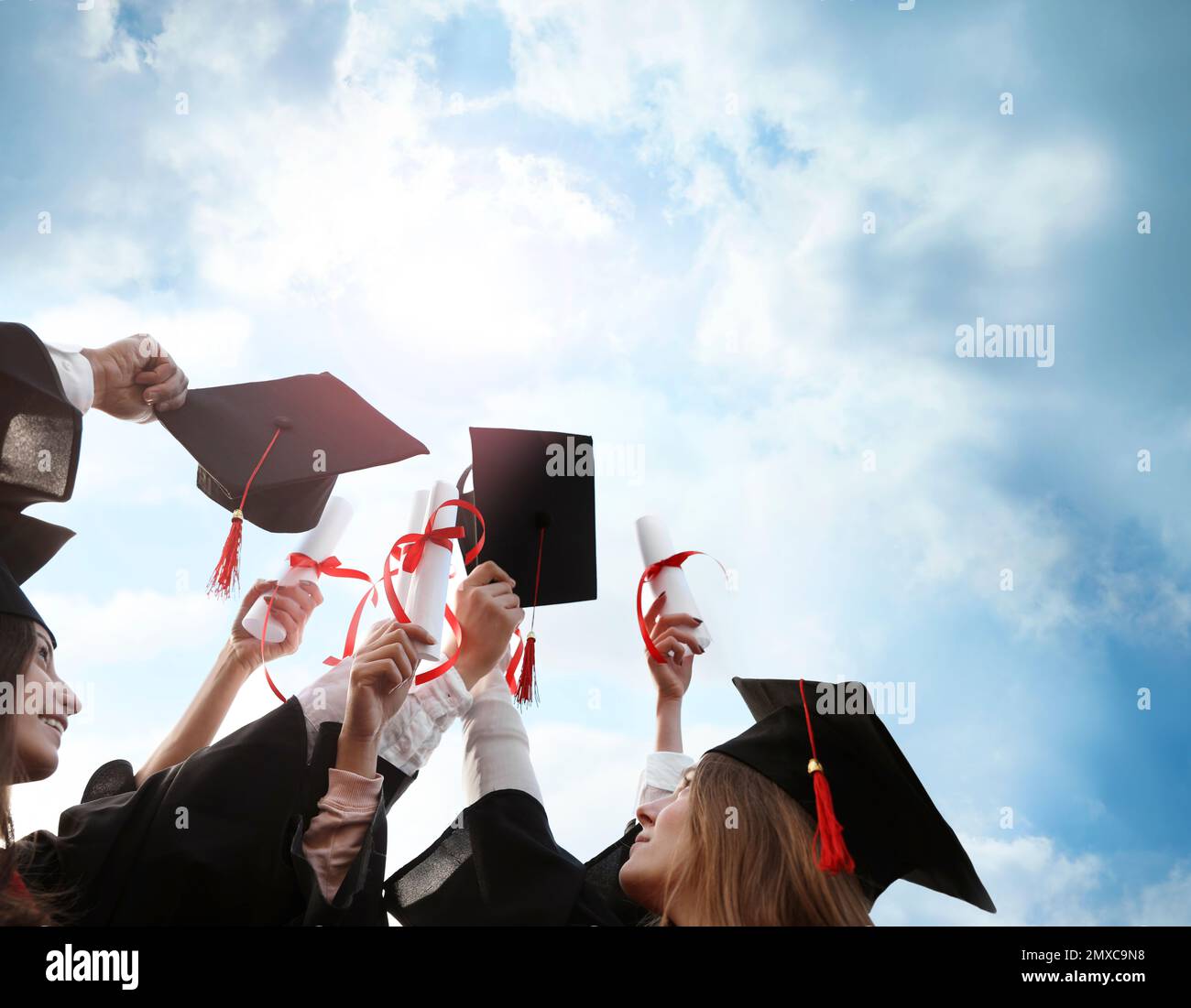 Group of students with diplomas outdoors. Graduation ceremony Stock Photo