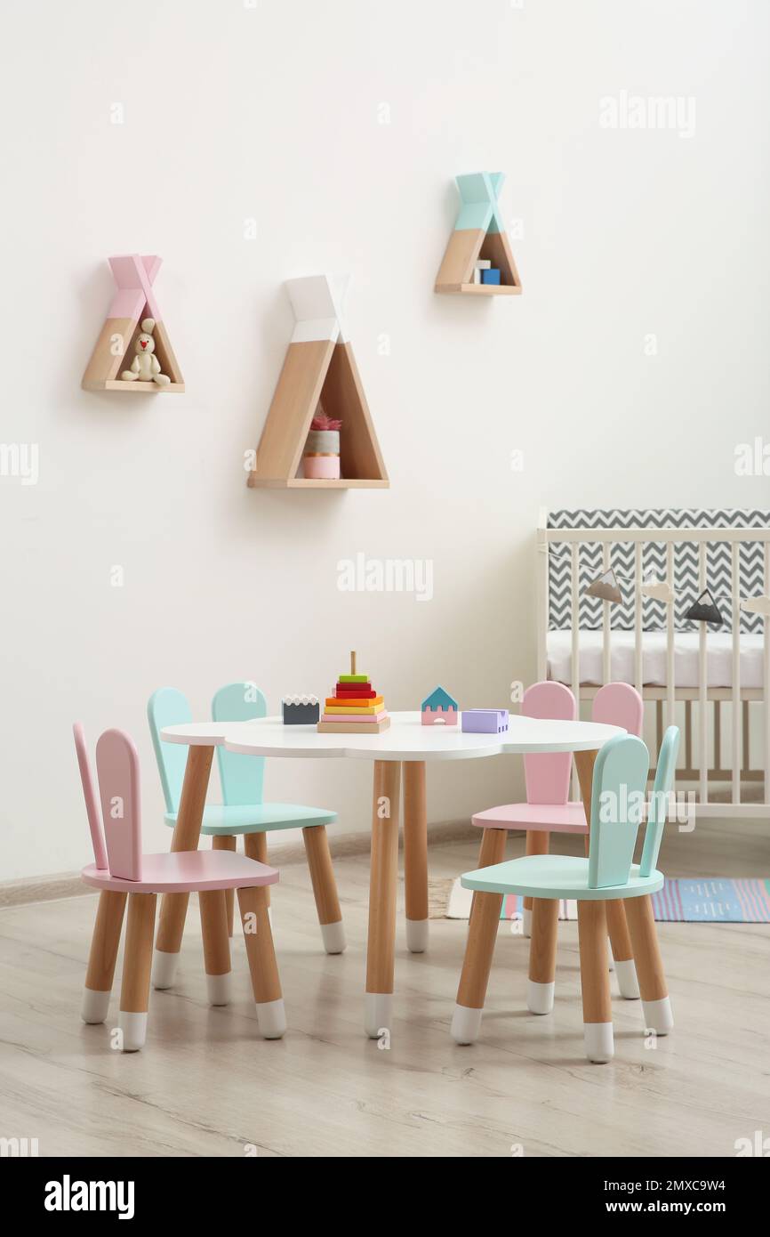 Little table and chairs with bunny ears in baby room. Interior design ...