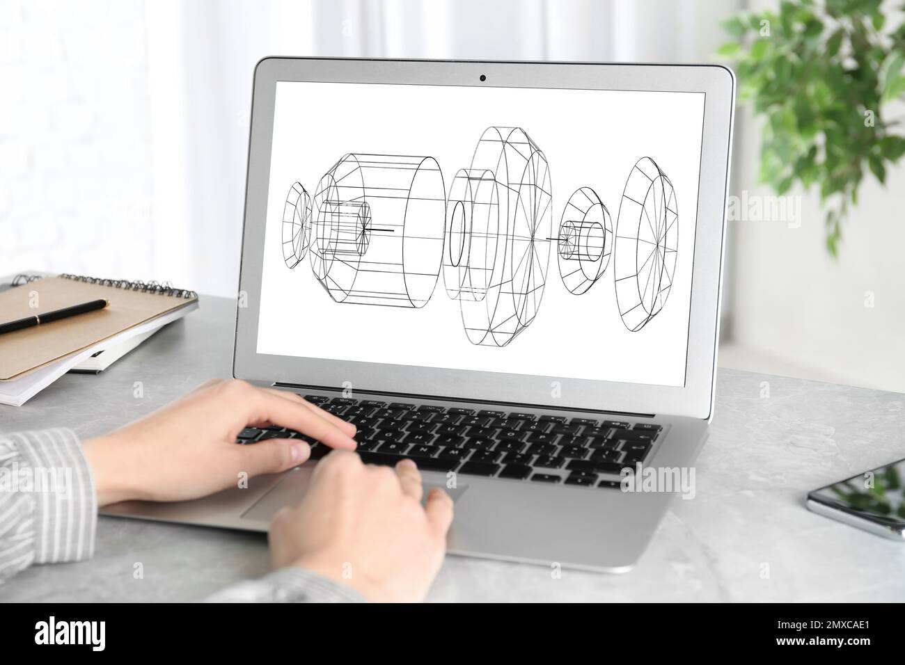 Female engineer working with 3d model of modern equipment on laptop indoors, closeup Stock Photo