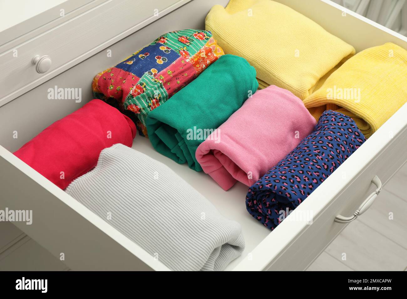 Folded clothes in open drawer. Apparel storage Stock Photo Alamy