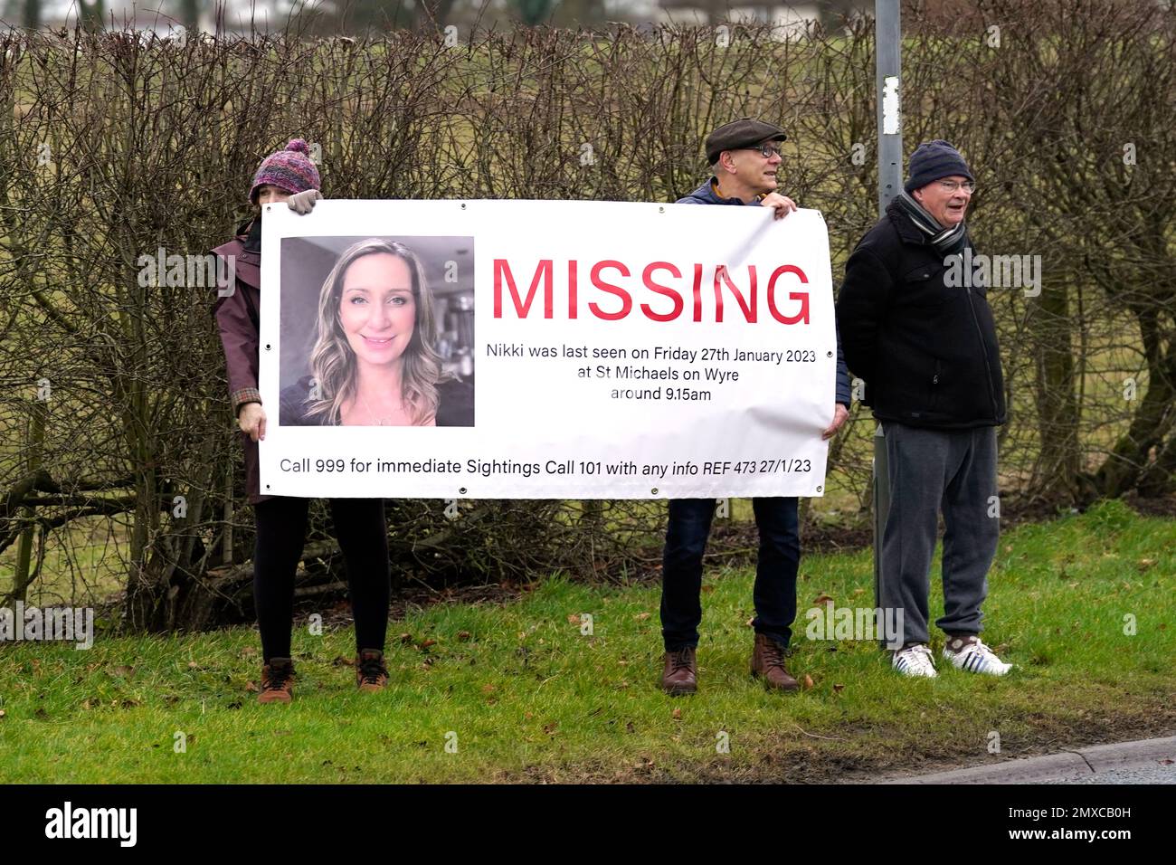 Members of the public line the road into St Michael's on Wyre, Lancashire, with missing posters of Nicola Bulley, 45, as police continue their search for the missing woman who was last seen on the morning of Friday January 27, when she was spotted walking her dog on a footpath by the nearby River Wyre. Picture date: Friday February 3, 2023. Stock Photo