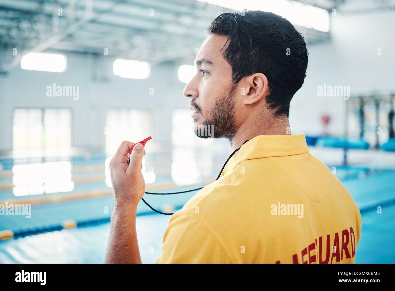 Lifeguard, whistle and swimming pool safety by man watching at indoor